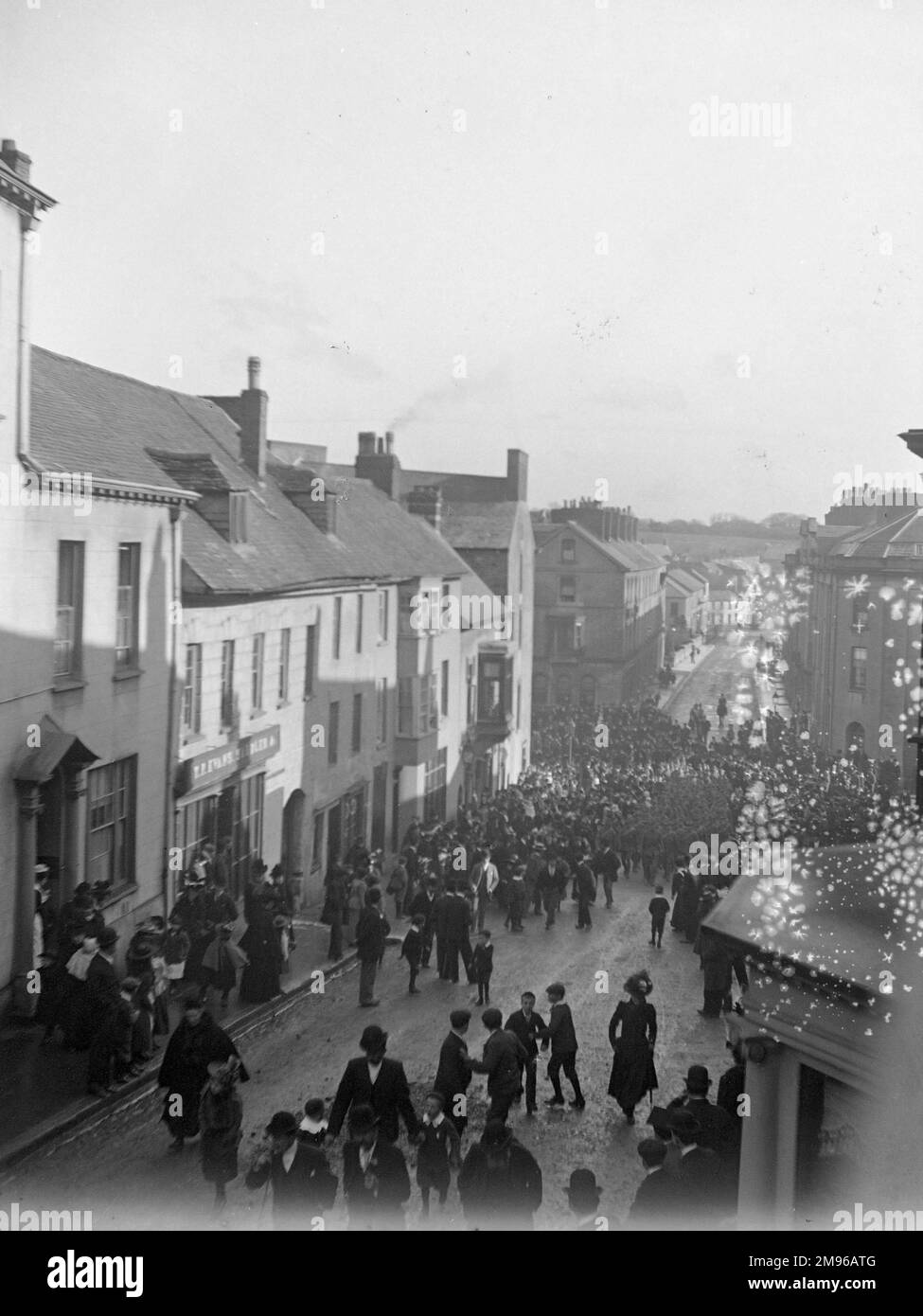 Soldiers parade up the High Street in Haverfordwest, Pembrokeshire, Dyfed, South Wales, watched by various townspeople, around the time of the outbreak of the First World War. Stock Photo