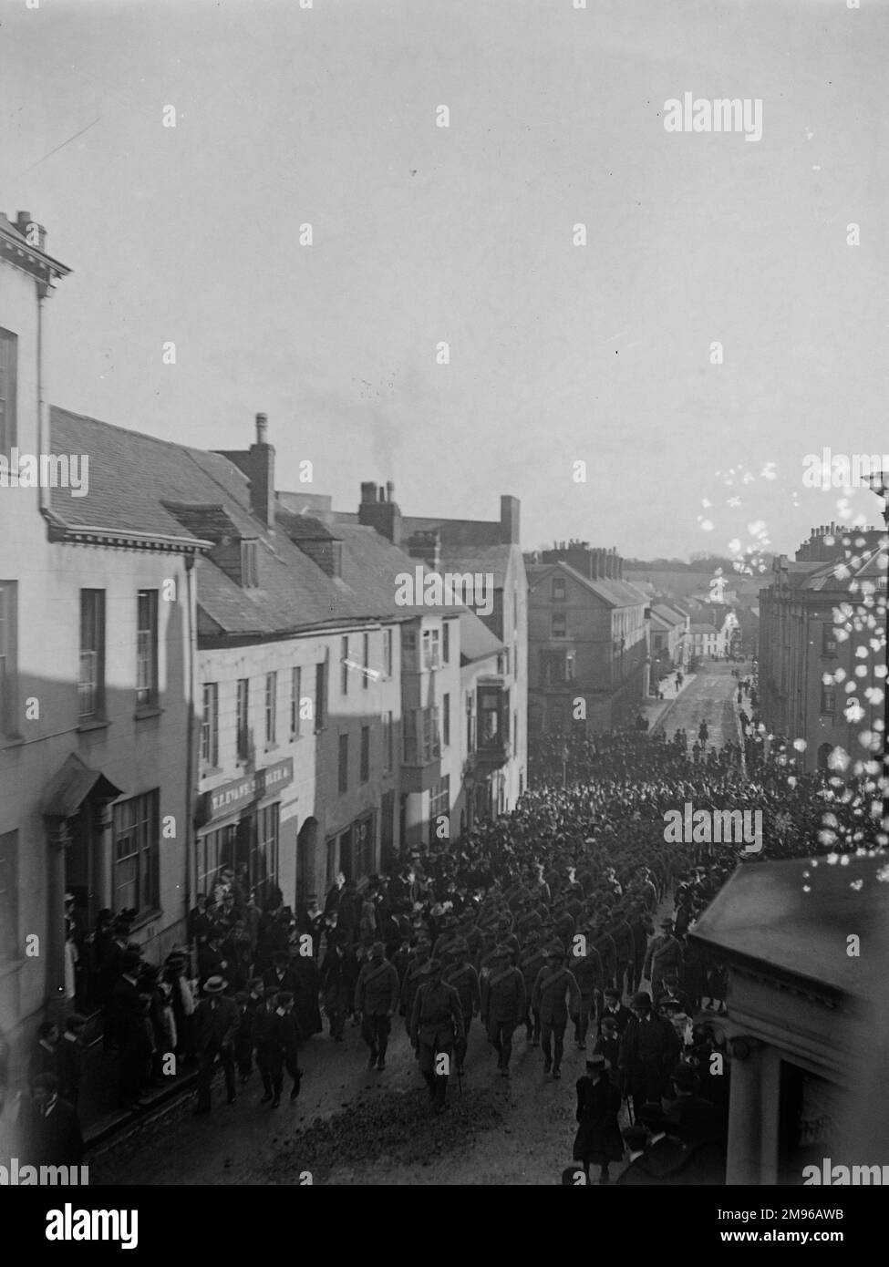 Soldiers marching up the High Street in Haverfordwest, Pembrokeshire, Dyfed, South Wales, watched by various townspeople, around the time of the outbreak of the First World War. Stock Photo