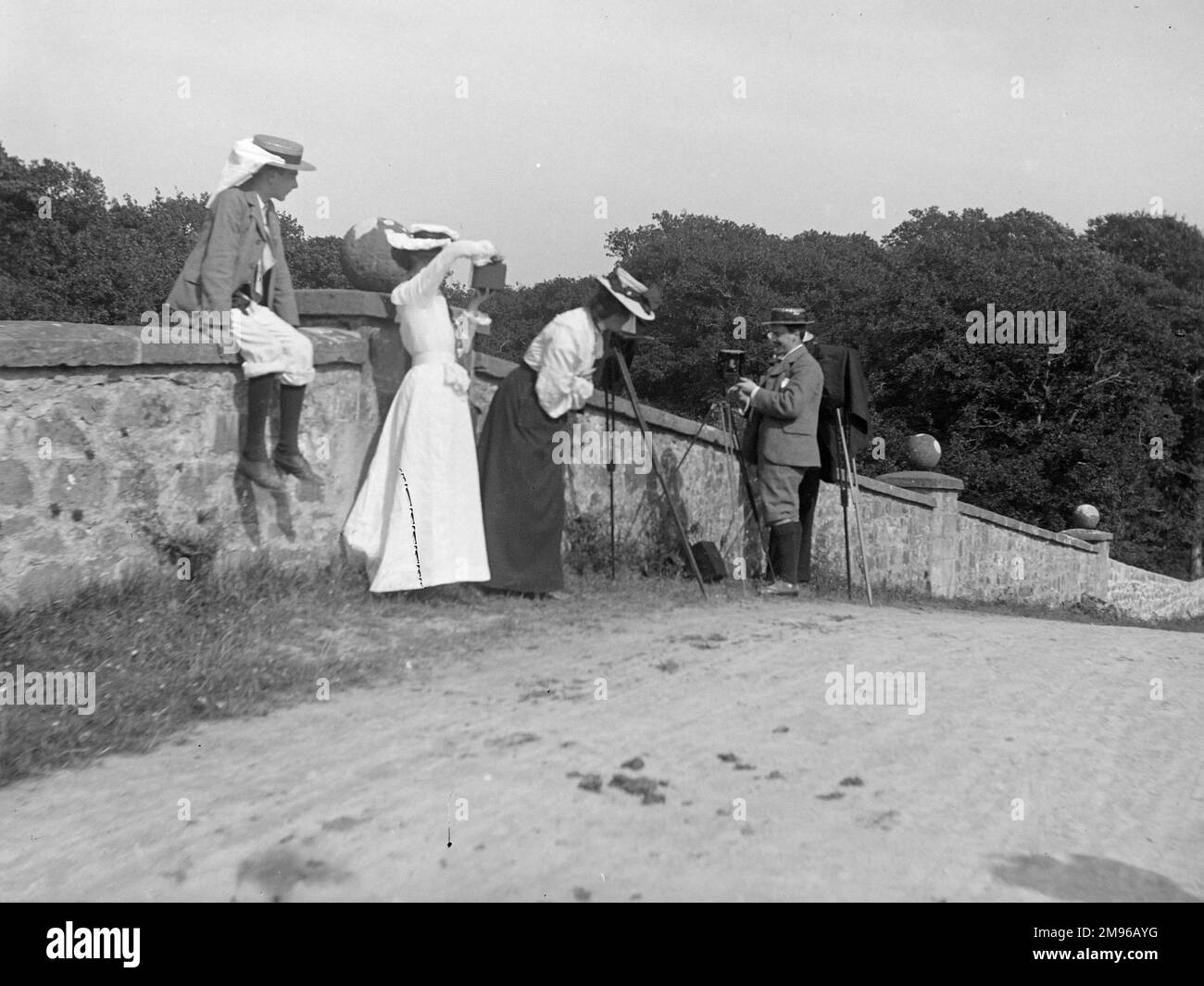 A photographic party on the bridge at Slebech, Pembrokeshire, West Wales.  Blackpool Bridge, crossing the River Cleddau, is a Grade II listed, single span bridge, built about 1825 for the de Rutzen family who owned Slebech Park at that time. Stock Photo