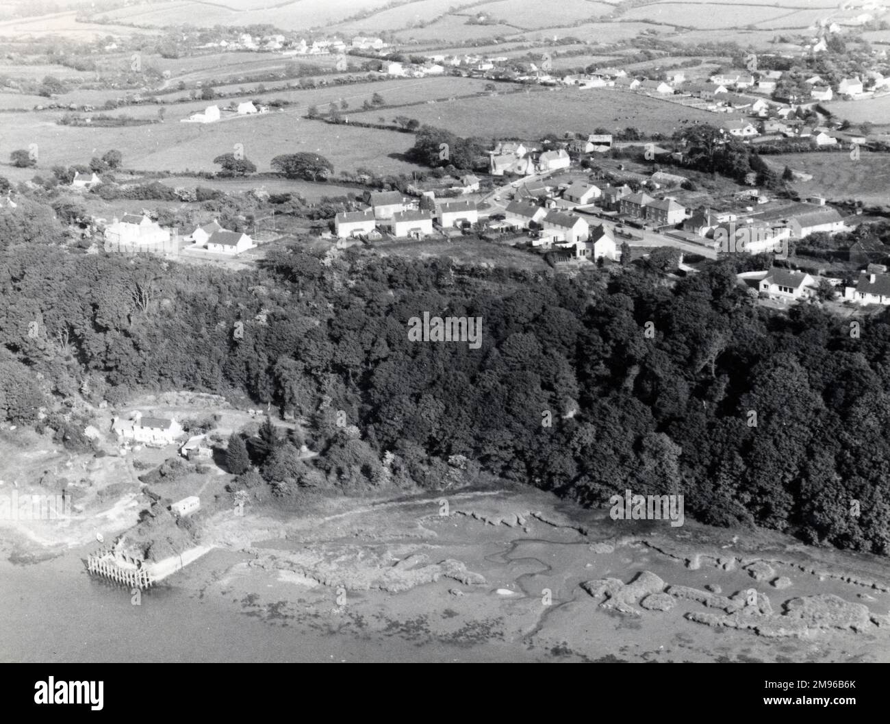 An aerial view of the coastal village of Hook, on the Western Cleddau, near Haverfordwest, Pembrokeshire, South Wales.  The quay can be seen in the foreground -- it was constructed in the late 18th century to facilitate the transportation of coal from Hook Colliery, which closed in 1947. Stock Photo