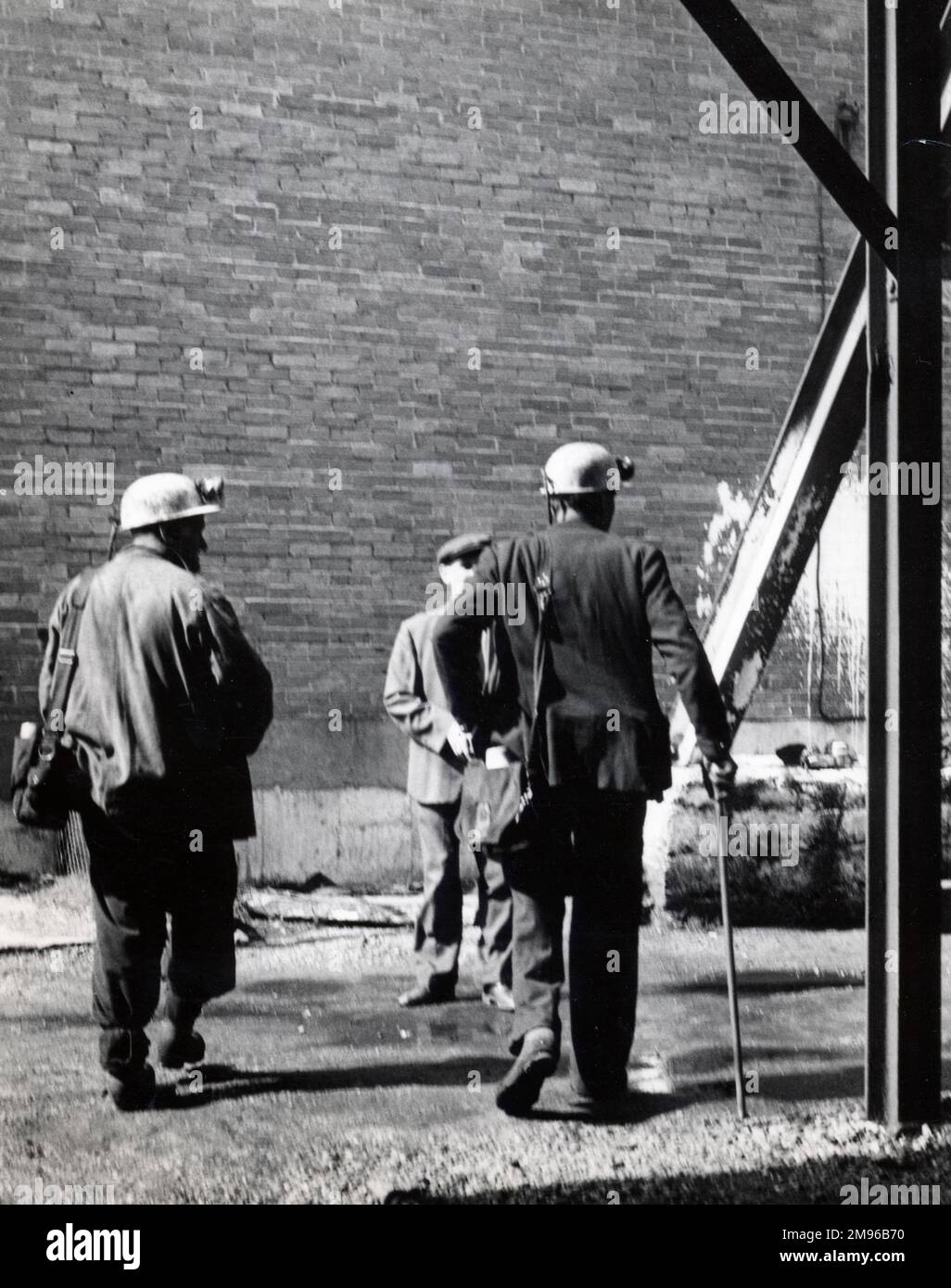 Two miners with a colliery official at a mine in South Wales. Stock Photo