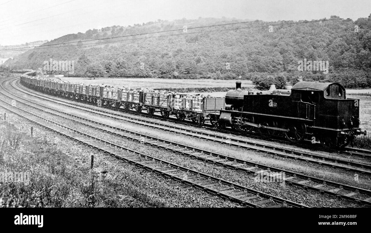 A one hundred truck coal train on the Great Western Railway, somewhere in South Wales.  The trucks belong to the John Lancaster & Co colliery company of Nant-y-glo (Nantyglo), and bear a griffin symbol. Stock Photo