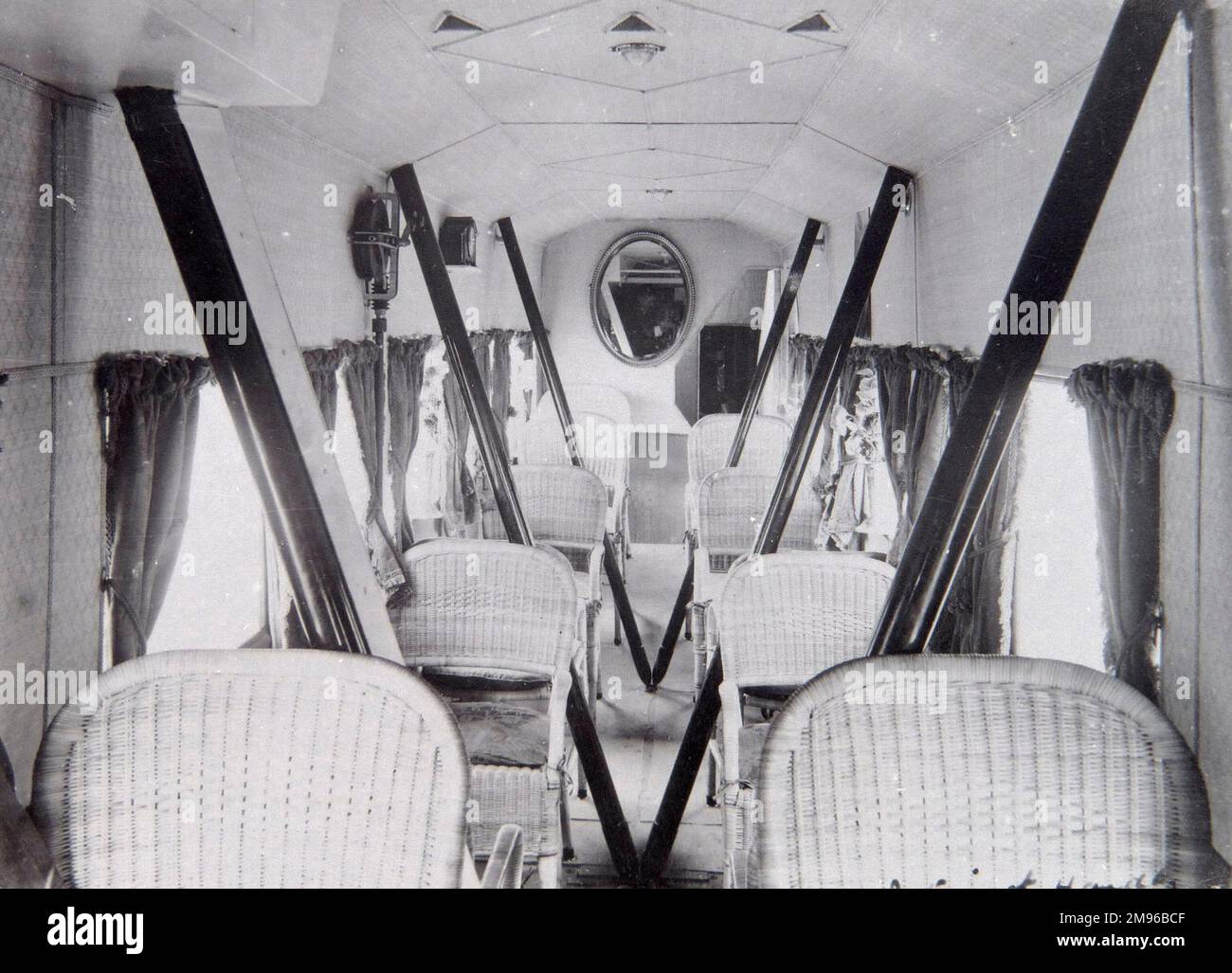 View of the interior of a London to Paris passenger aircraft, a Handley Page O/700, in the early days of aviation. There are curtains at the windows, and the seating is made of wickerwork, in Lloyd Loom style. Stock Photo