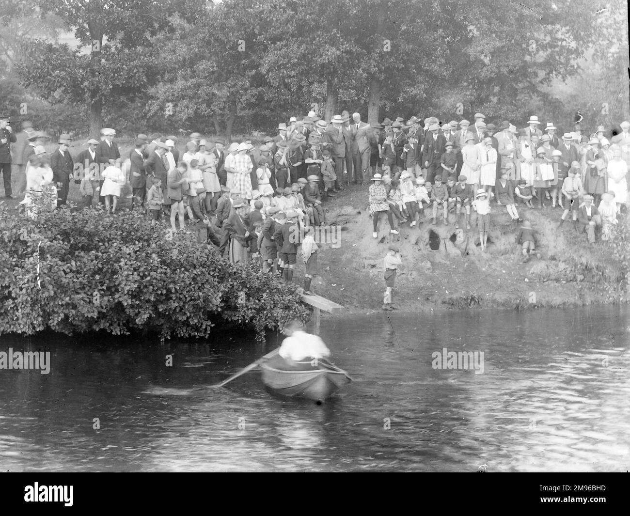 A crowd of Edwardian people, adults and children, at a boating event in the Wye Valley, probably in the Mid Wales area. Stock Photo