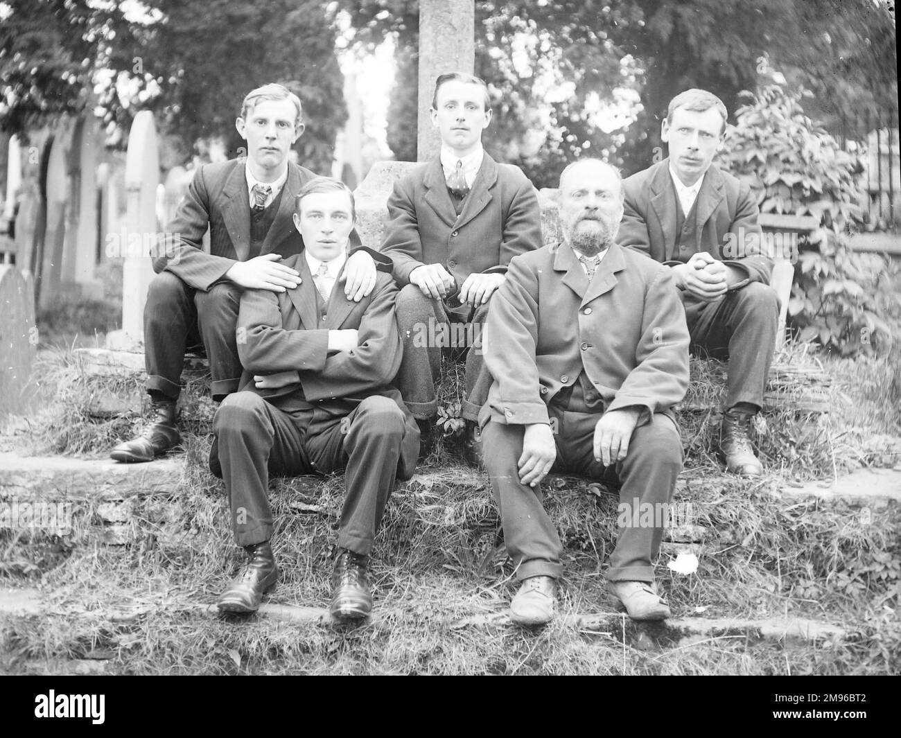 A father and his four sons in a graveyard, Mid Wales. From their