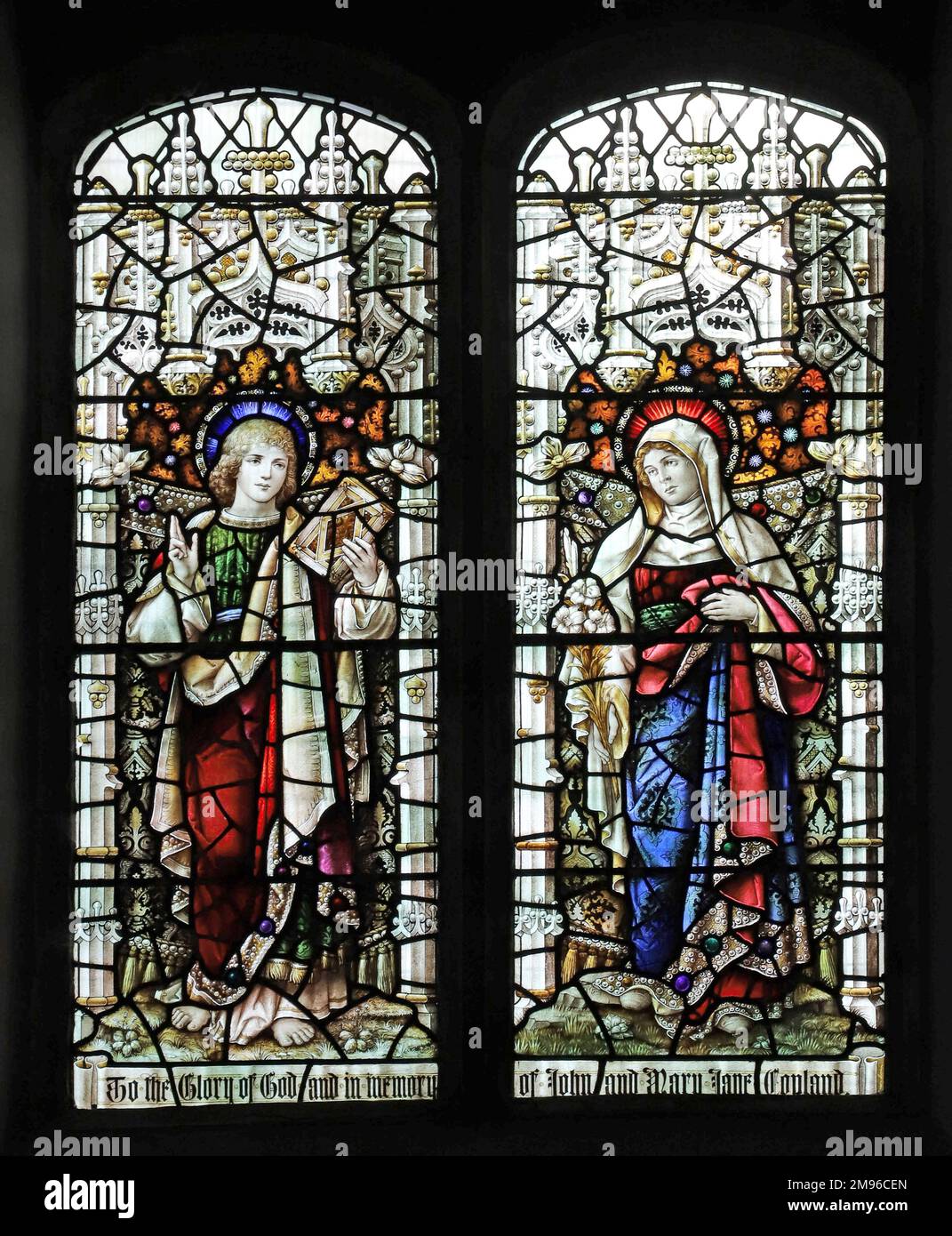 Stained glass window by Percy Bacon & Brothers depicting St John Evangelist and the Blessed Virgin Mary, Minster Abbey Church, Minster on Sea, Kent Stock Photo