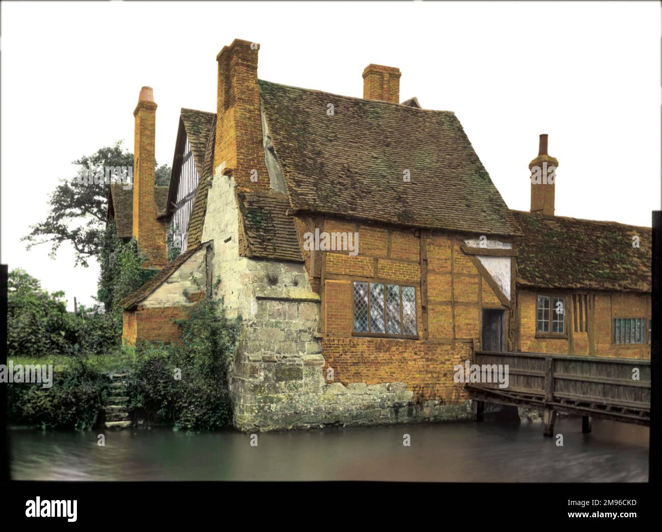 An old timbered house at the side of a river Stock Photo - Alamy