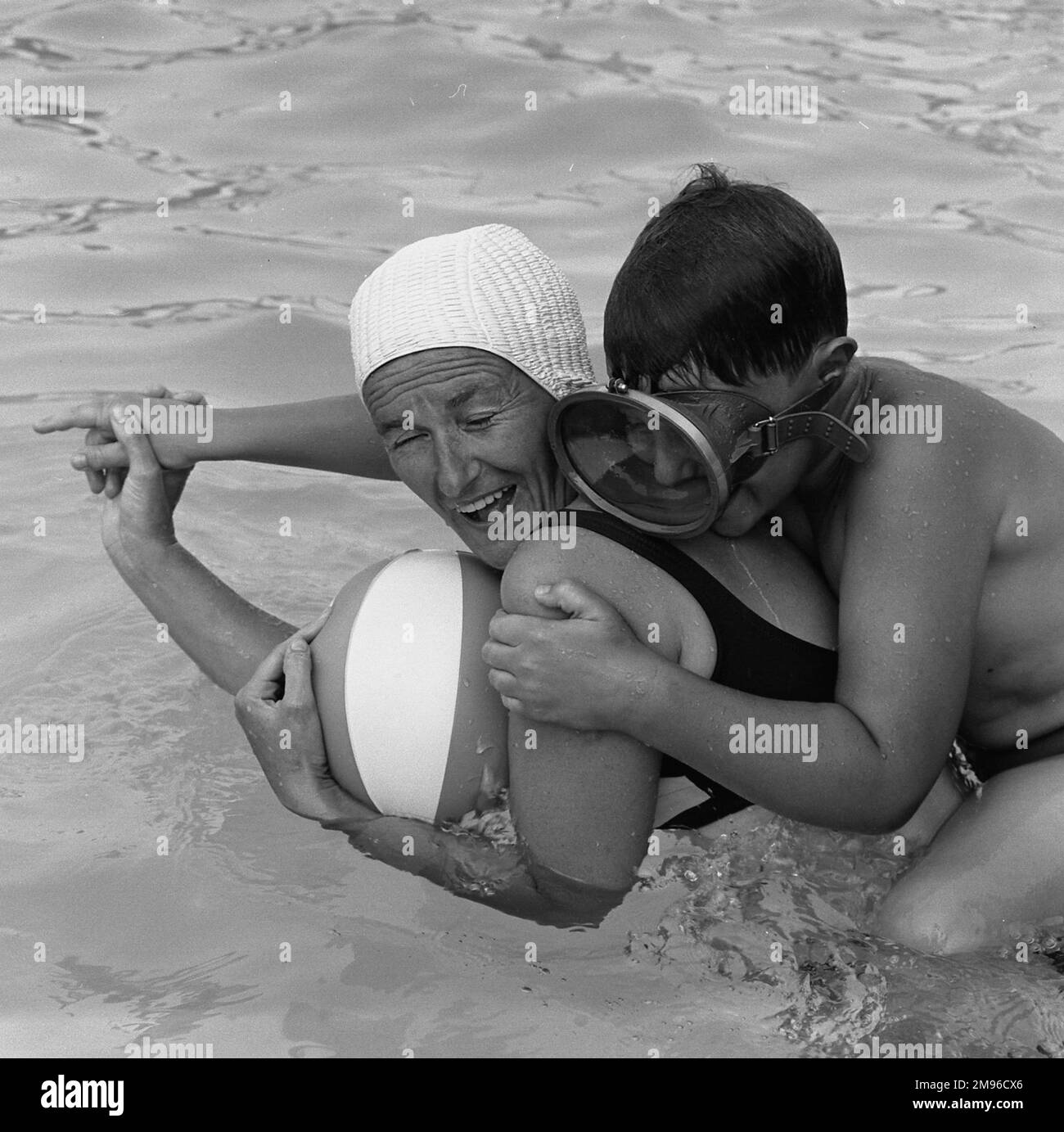 A mother and her son larking about in a swimming pool. Stock Photo