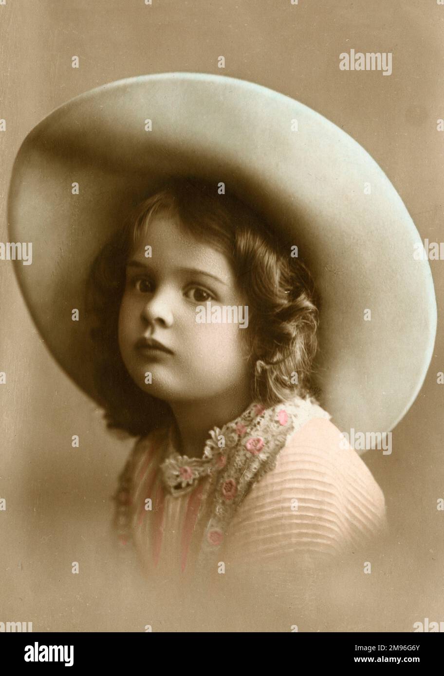 A sweet little girl wearing a wide-brimmed hat Stock Photo