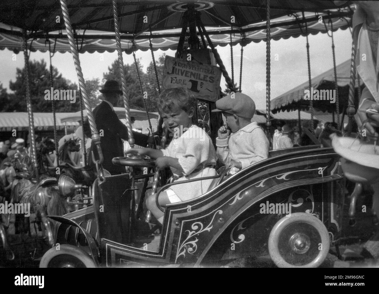 Children on a fairground ride costing one penny. Stock Photo