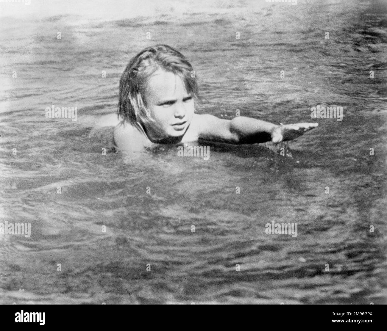 JACKIE COOGAN circa 1922 candid swimming near his mountain retreat in the high Sierras publicity for Jackie Coogan Productions Stock Photo