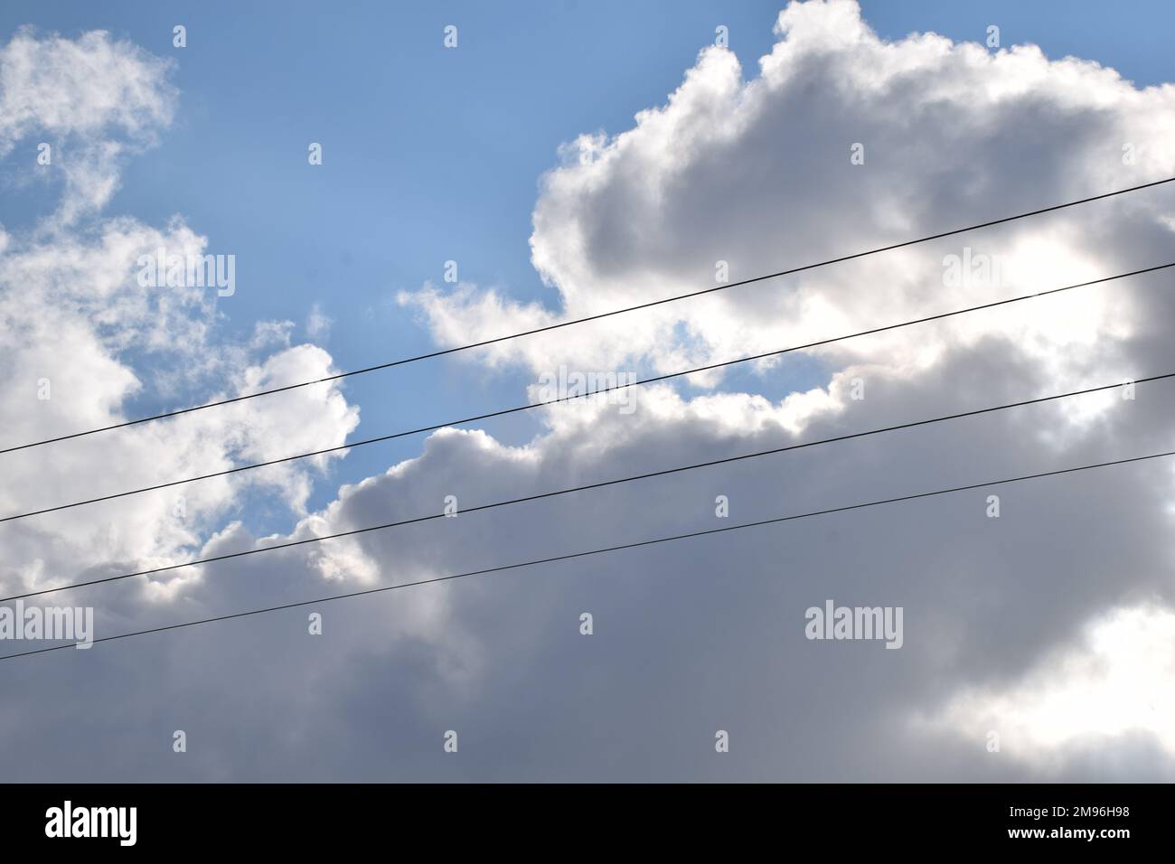 Sustainable energy concept, Sustanability, clouds in the sky with energy wires, energy concept, Renewable energy, solar power, electricity Stock Photo