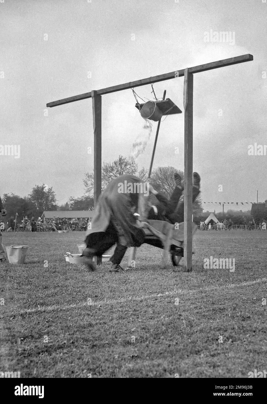 A comic event at a local fair, involving a wheelbarrow race and a