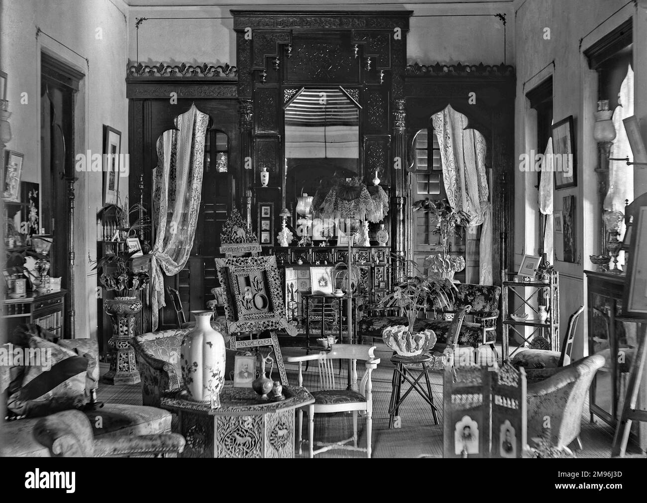 A Victorian style domestic interior with a large fireplace, and ...