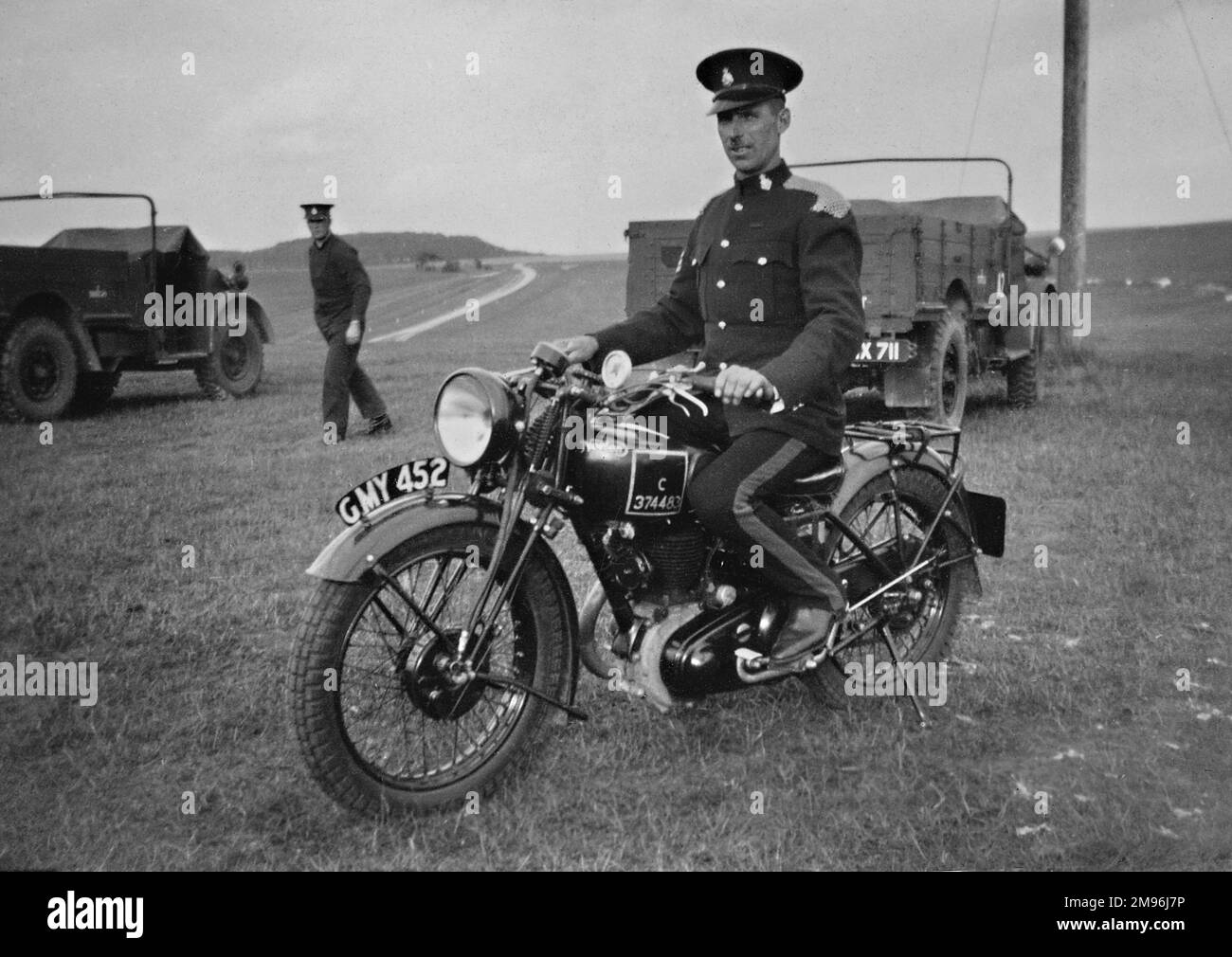 Soldier in dress uniform on a motorbike in a field near Okehampton, Devon. Stock Photo