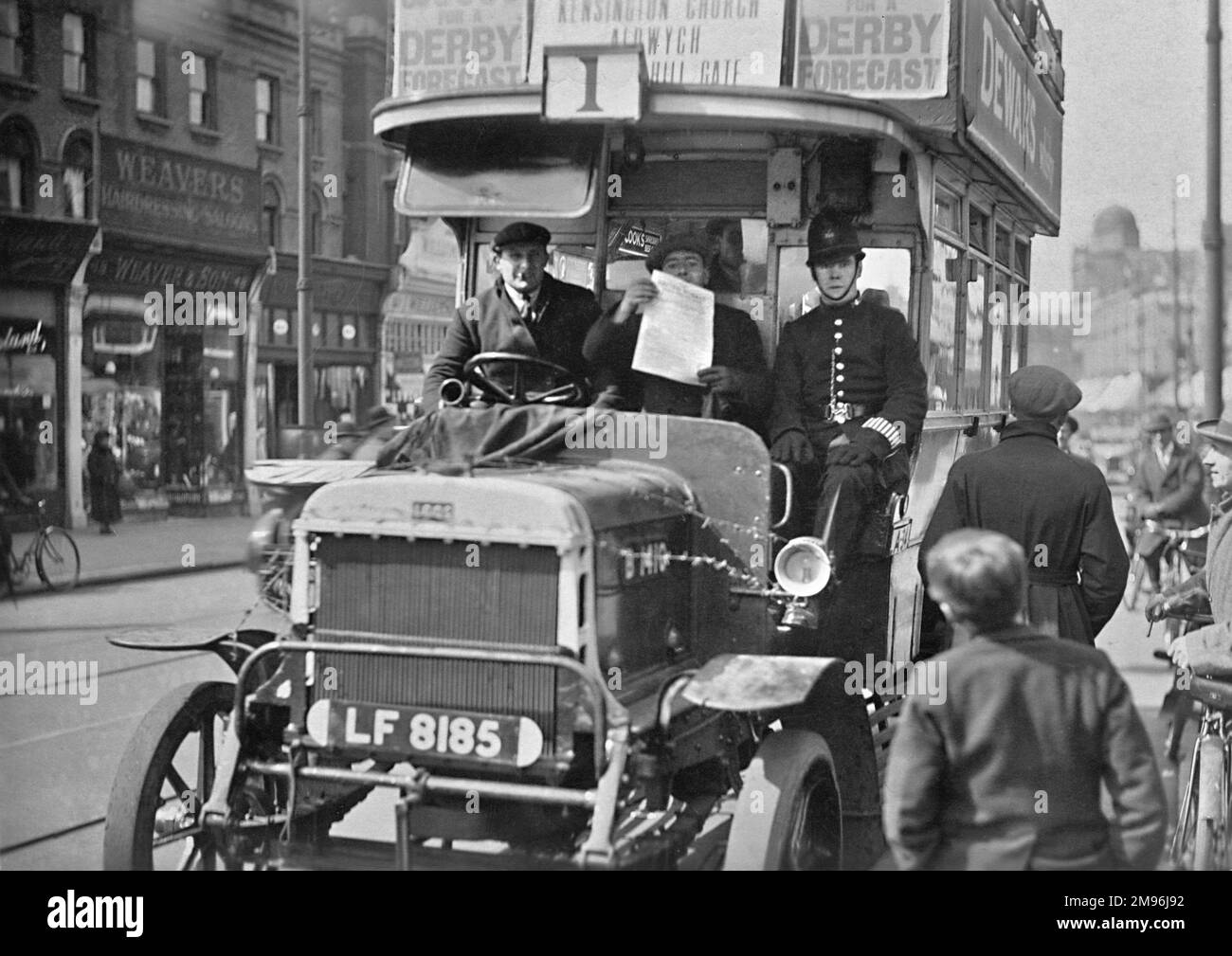 London bus during the General Strike, Route 1, destined for Kensington Church, the Aldwych and Notting Hill Gate.  Alongside the driver, on the outside of the vehicle, sits another man and a policeman, acting as protection for the working bus operators. Stock Photo