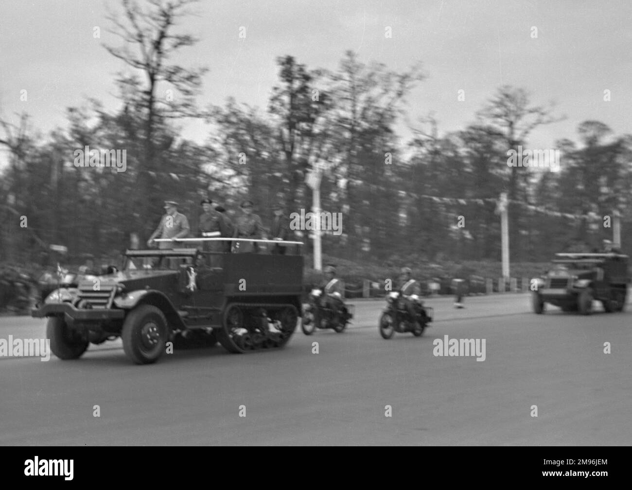 A military parade with jeeps and motorbikes. Stock Photo