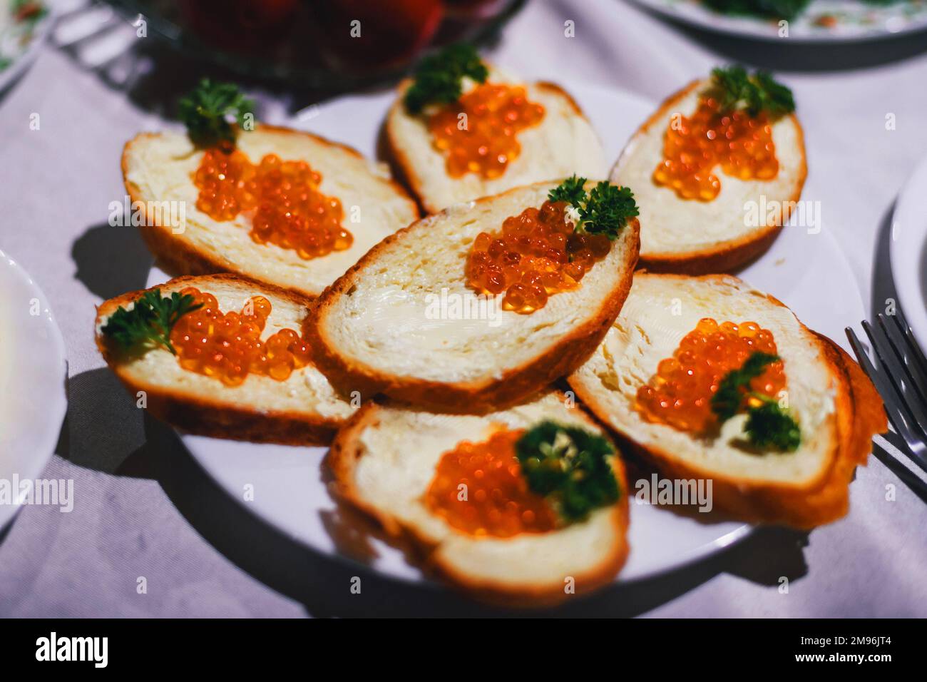 sandwiches with red caviar fish and butter and parsley. Traditional