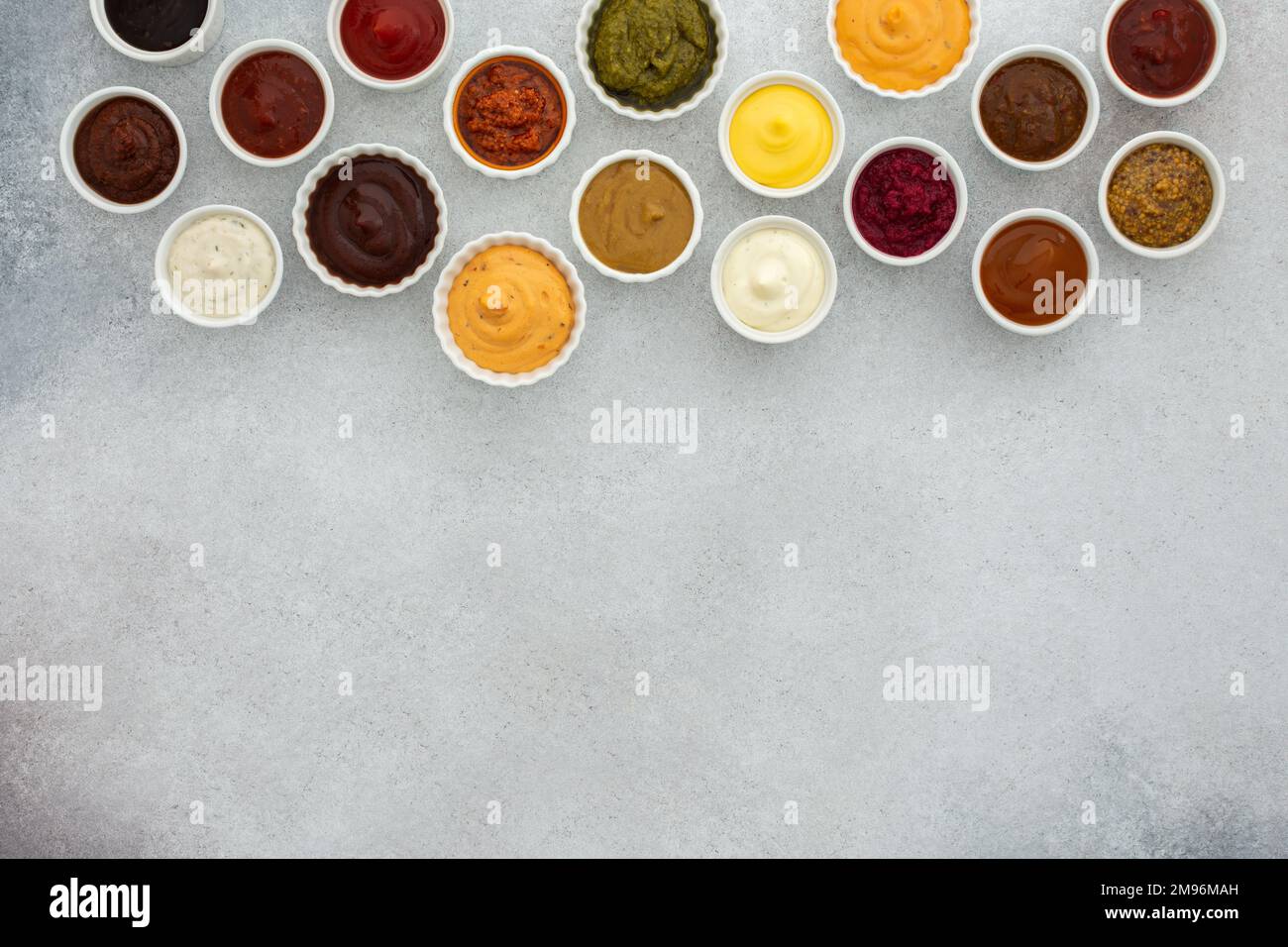 Different types of sauces in bowls , ketchup and mayonnaise, pesto and