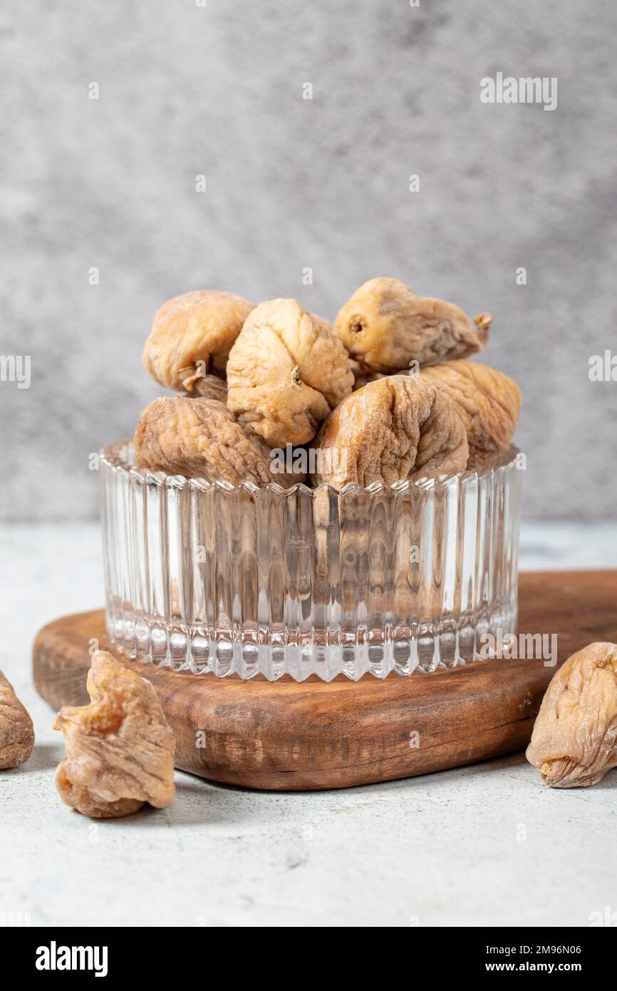 Dried figs on stone background. Sundried dried figs in glass bowl