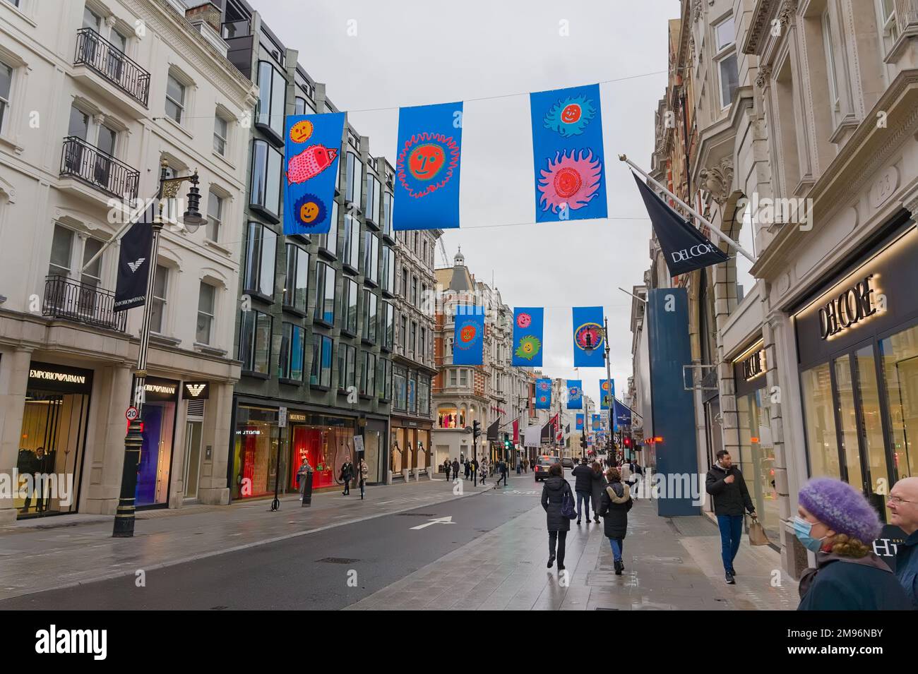 perspective view of a famous shopping street near Mayfair with colorful flags overhead Stock Photo