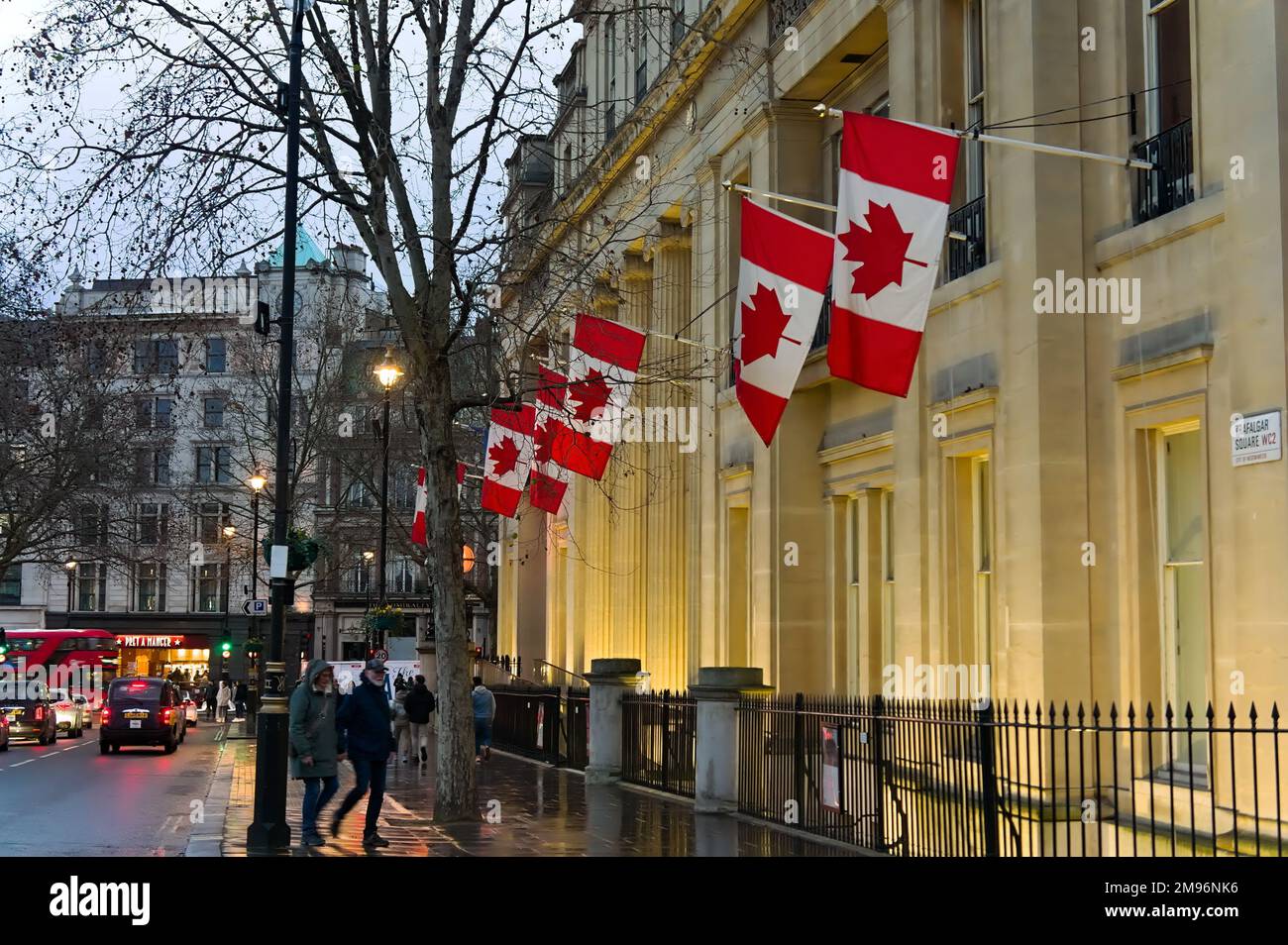 Canada House (the Canadian Embassy) with its row of flags illuminated on Trafalgar Square. Stock Photo