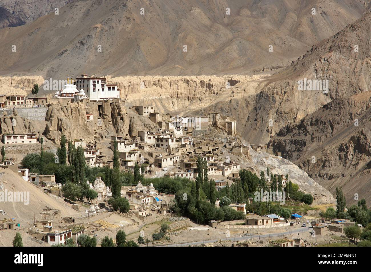 India, Jammu and Kashmir, Ladakh, Lamayuru: View towards monastery, village and oasis below, rock formatiom,. Stock Photo