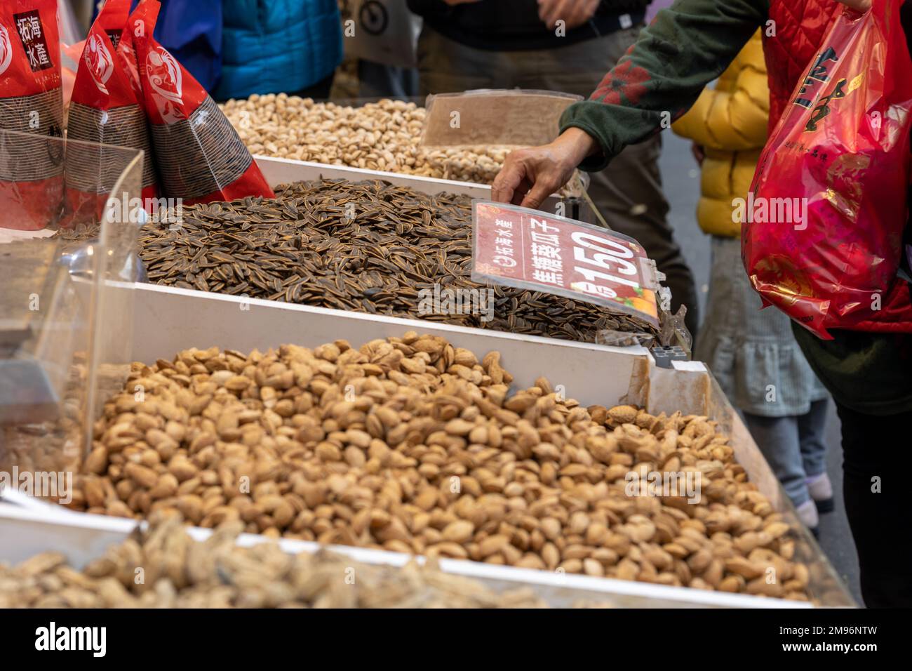 Sunflower seeds, pistachio nuts and peanuts on sale at Dihua Street New Year's market in Taipei ahead of the Lunar New Year and the Year of the Rabbit Stock Photo