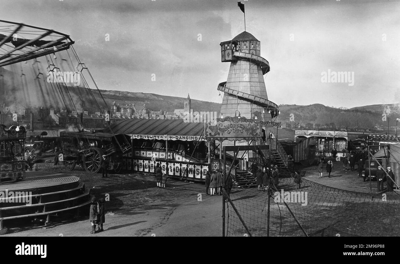 A fairground at Burntisland, Fife, Scotland, with a helter skelter at the centre. Stock Photo