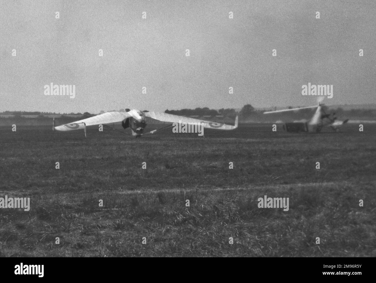 Two gliders in a field. The one on the left is a Westland-Hill Pterodactyl IV. The one on the right is a Cierva C.19 (Mk.I, II or III). Stock Photo