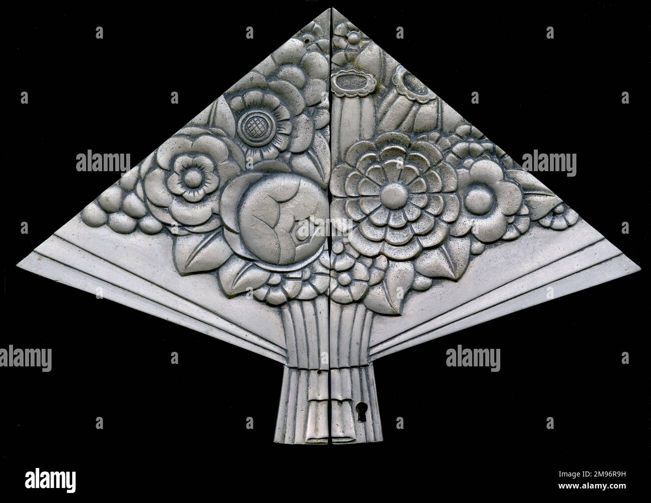 Decorative plated bronze in the shape of a bouquet of flowers, with a keyhole below. Stock Photo