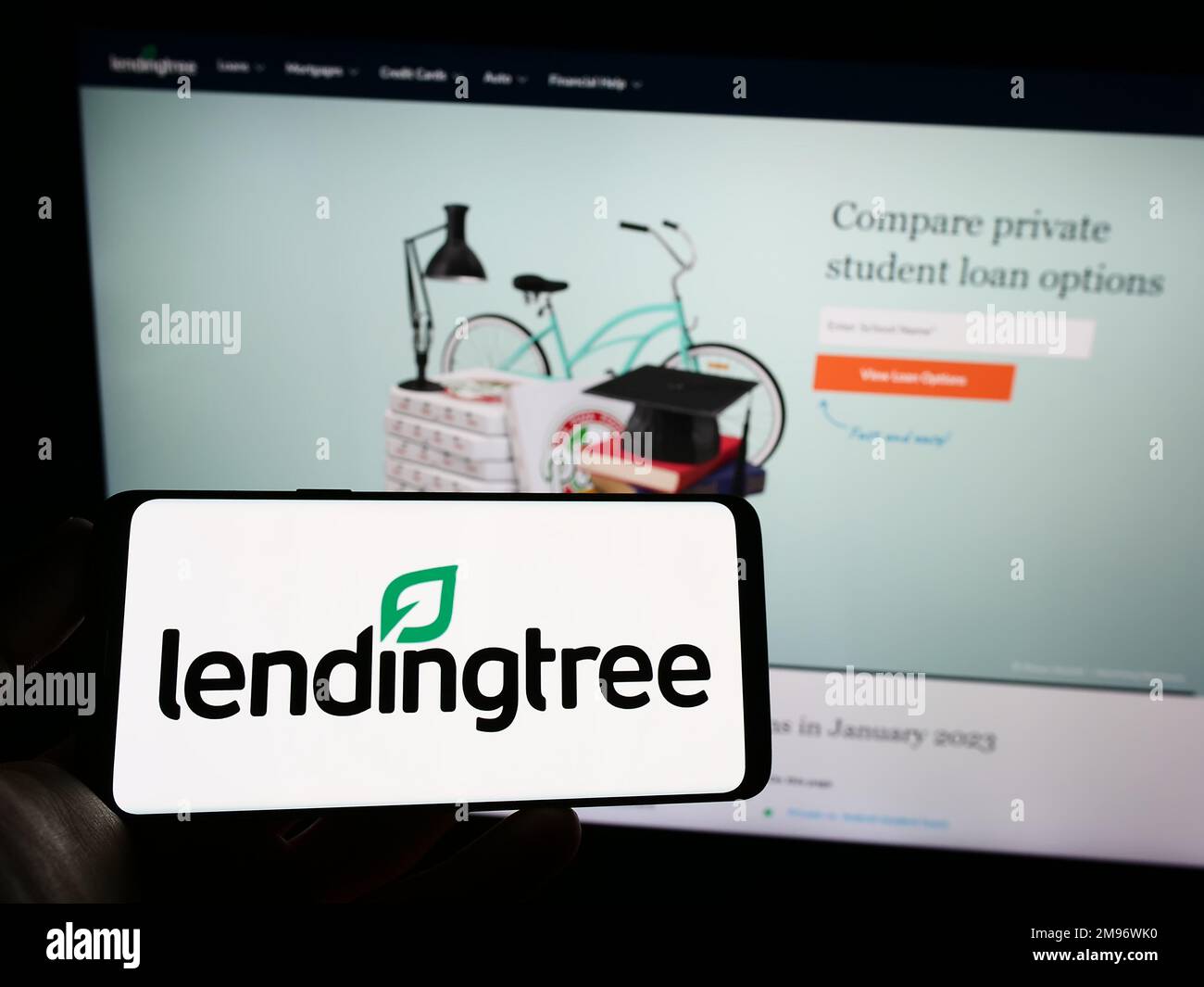 Person holding smartphone with logo of US lending marketplace company