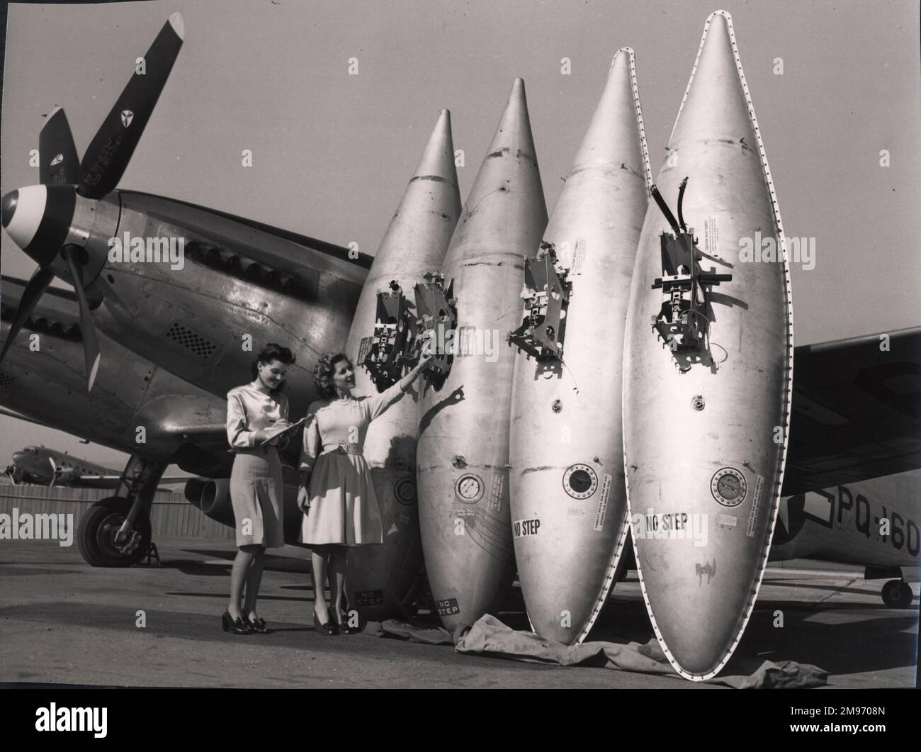 Drop tanks, two young ladies and a P-82 Twin Mustang! Stock Photo