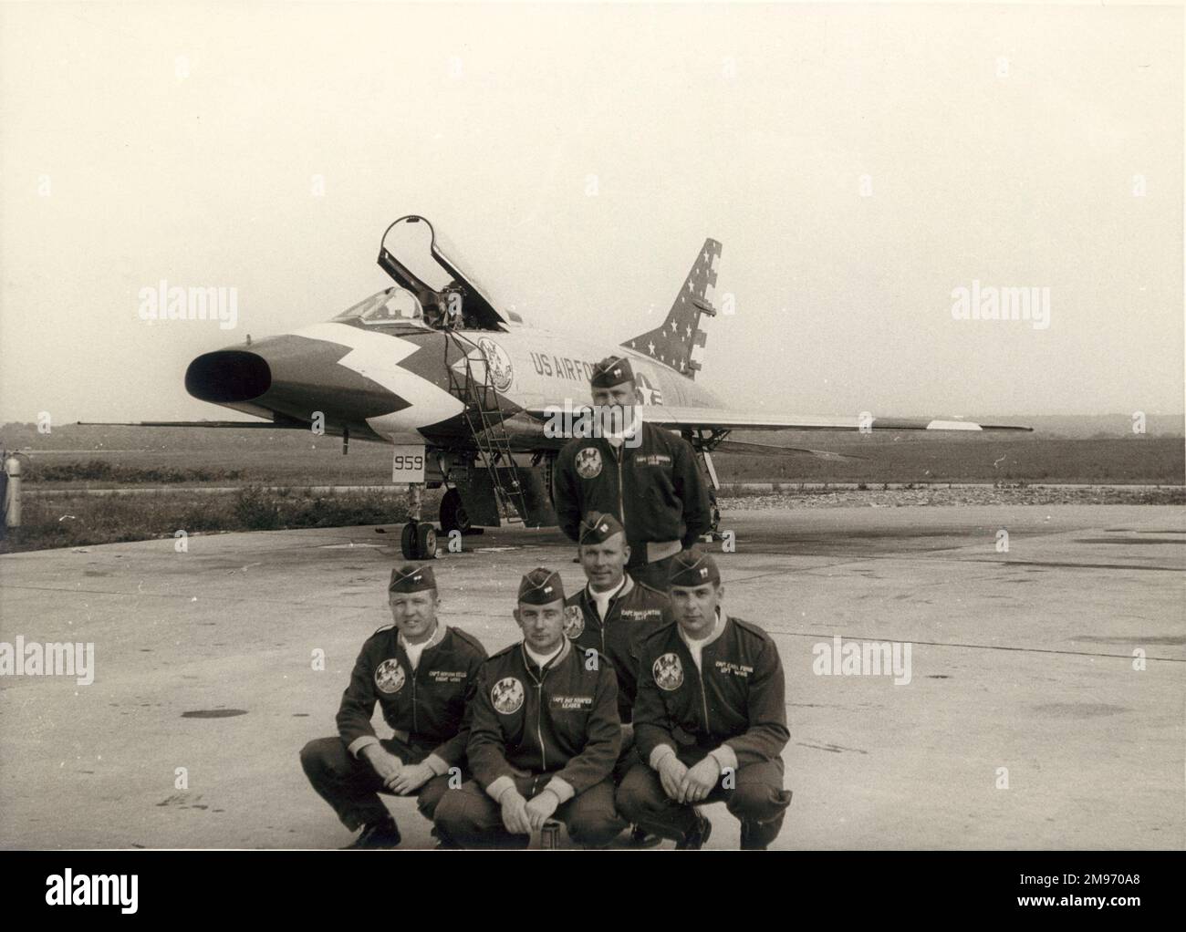 North American F-100C Super Sabre of the Skyblazers aerobatic team. Front row: Capts Gordon Eelis (right wing), Pat Kramer (leader), Carl Funk (left wing). Behind: Capt John Clayton (slot). Standing: Capt Bill Gordon (solo). Stock Photo