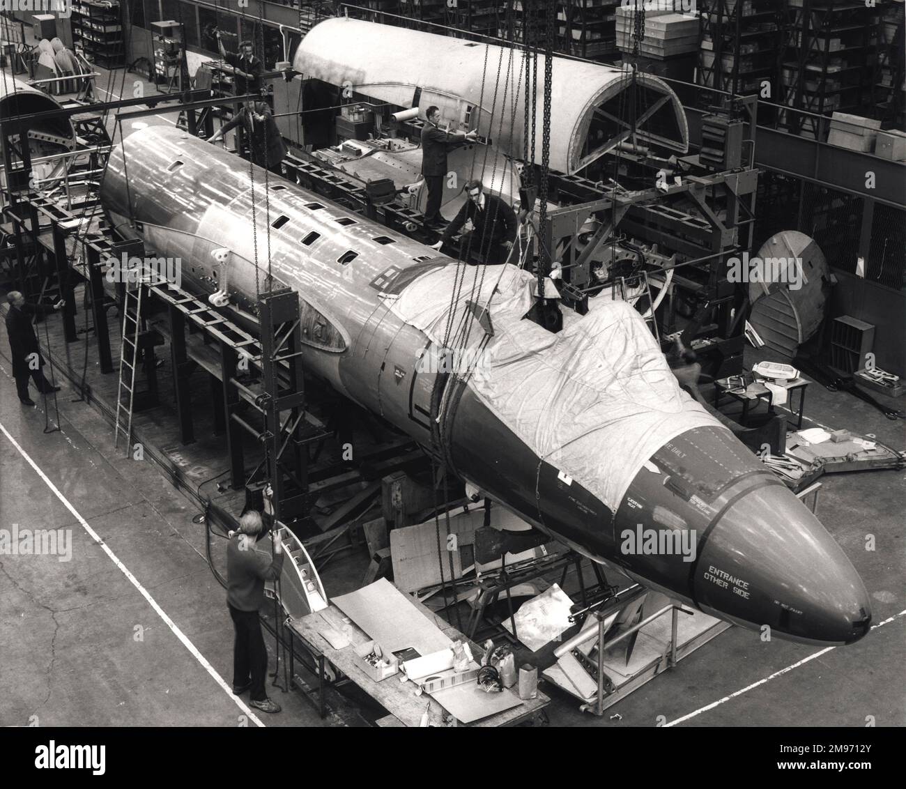 Ex-RAF English Electric Canberras being rebuilt for export at Samlesbury. November 1970. In the background the upper fuselage section is being replaced after comprehensive rebuild of the centre fuselage which includes fitment of a new main spar forging. The re-built fuselage in the foreground is being removed from its jig ready for the next stage. Stock Photo
