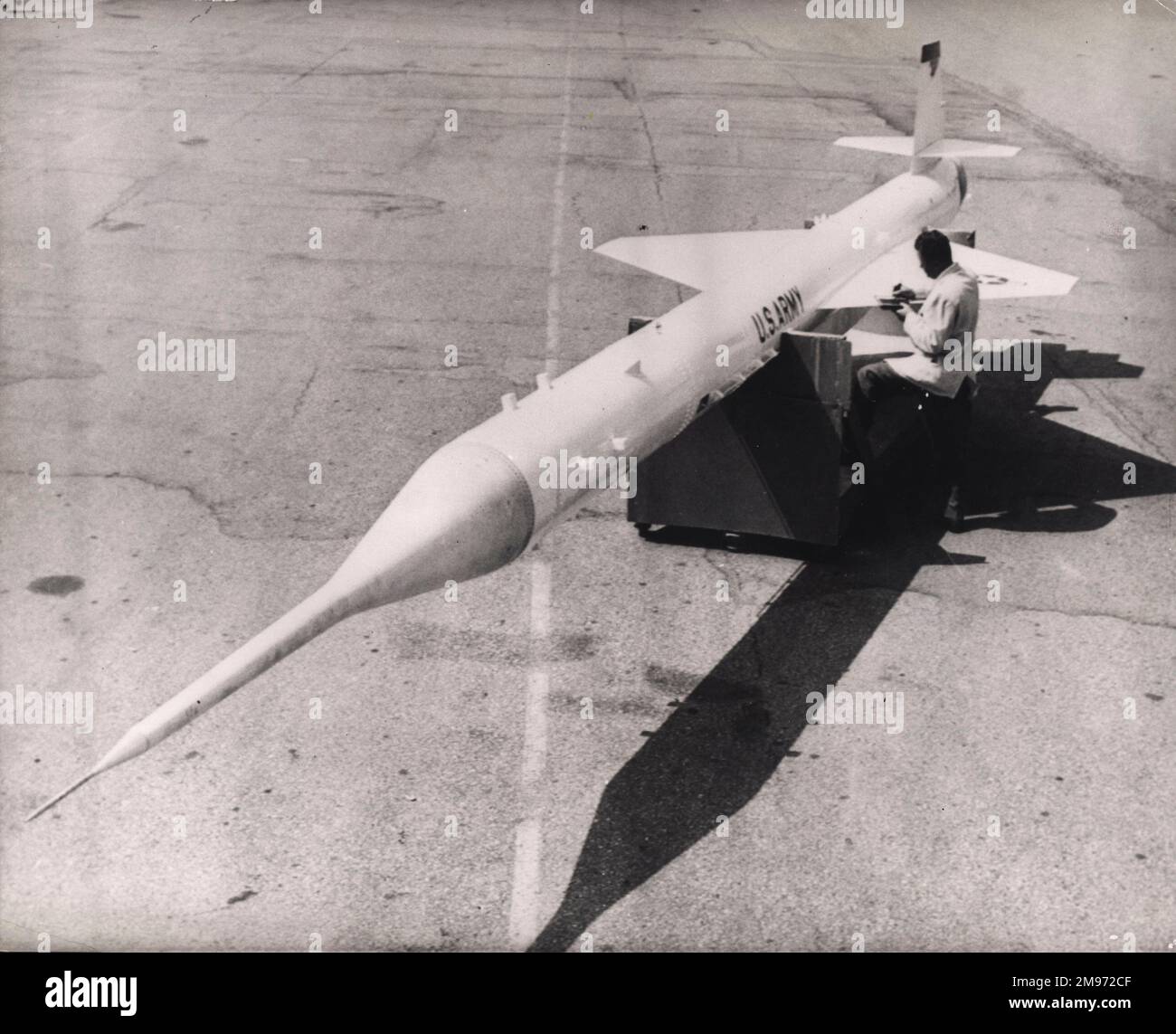 A technician checks over a Lockheed X-7 supersonic guided target missile at Sunnyvale, California, June 1958. The missile is without its solid booster. Stock Photo