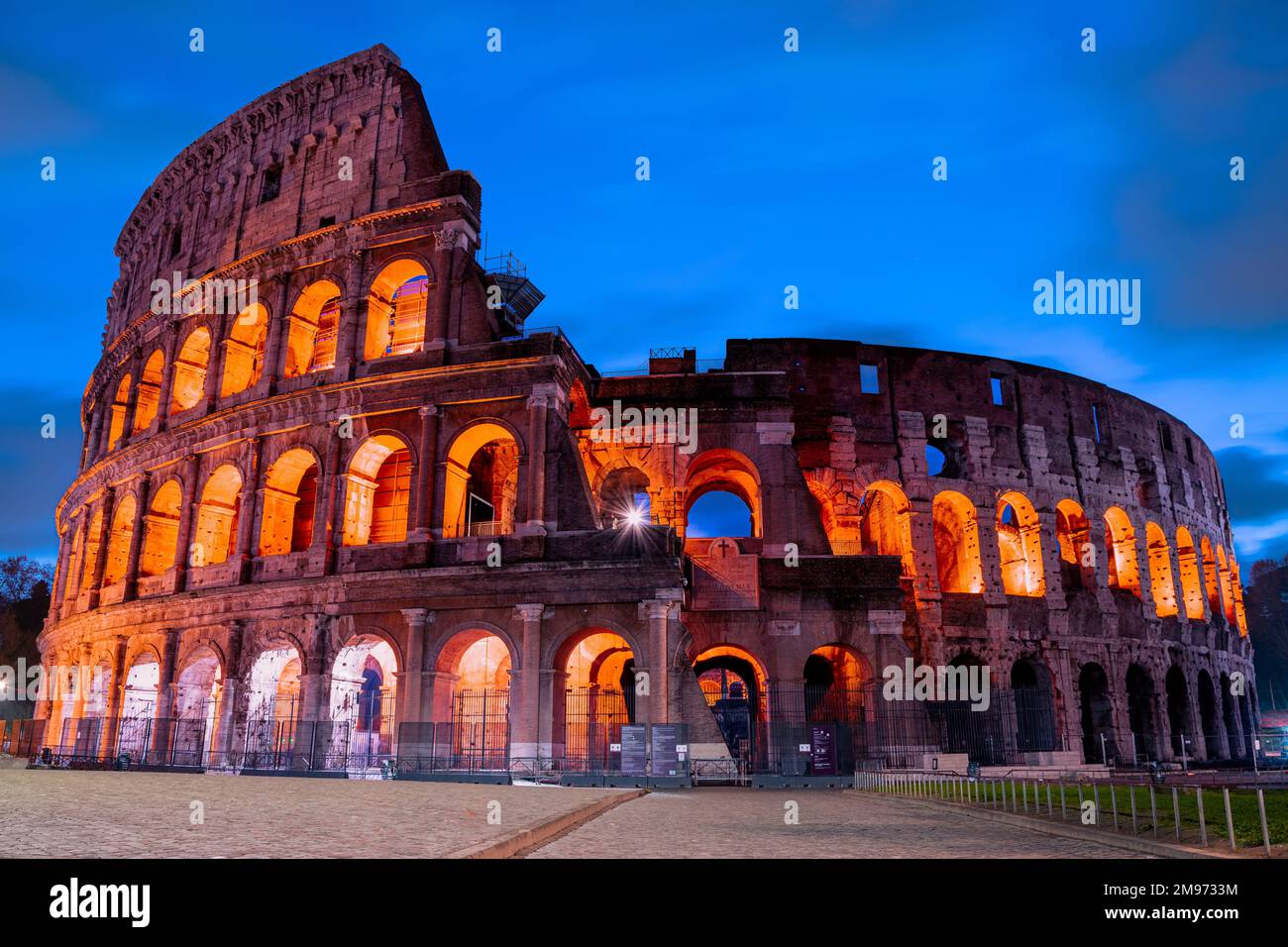 Authentic picture of the great Colosseum of Rome from outside before sunrise. Sunrise at the iconic Roman Colosseum. Stock Photo