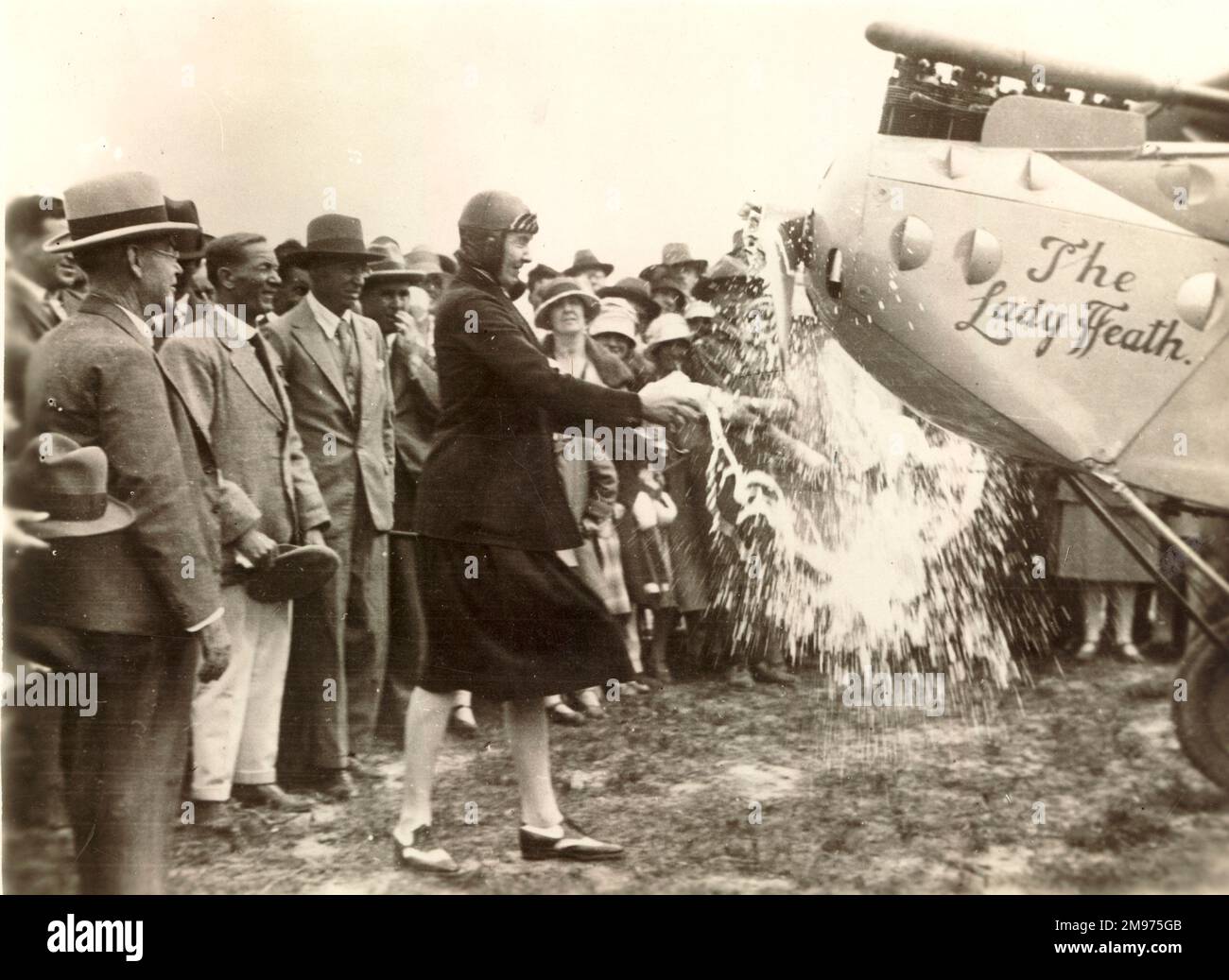 Mary, Lady Heath (1896-1939), Irish aviator, christens the aircraft (a DH.60 Moth) named after her. Stock Photo
