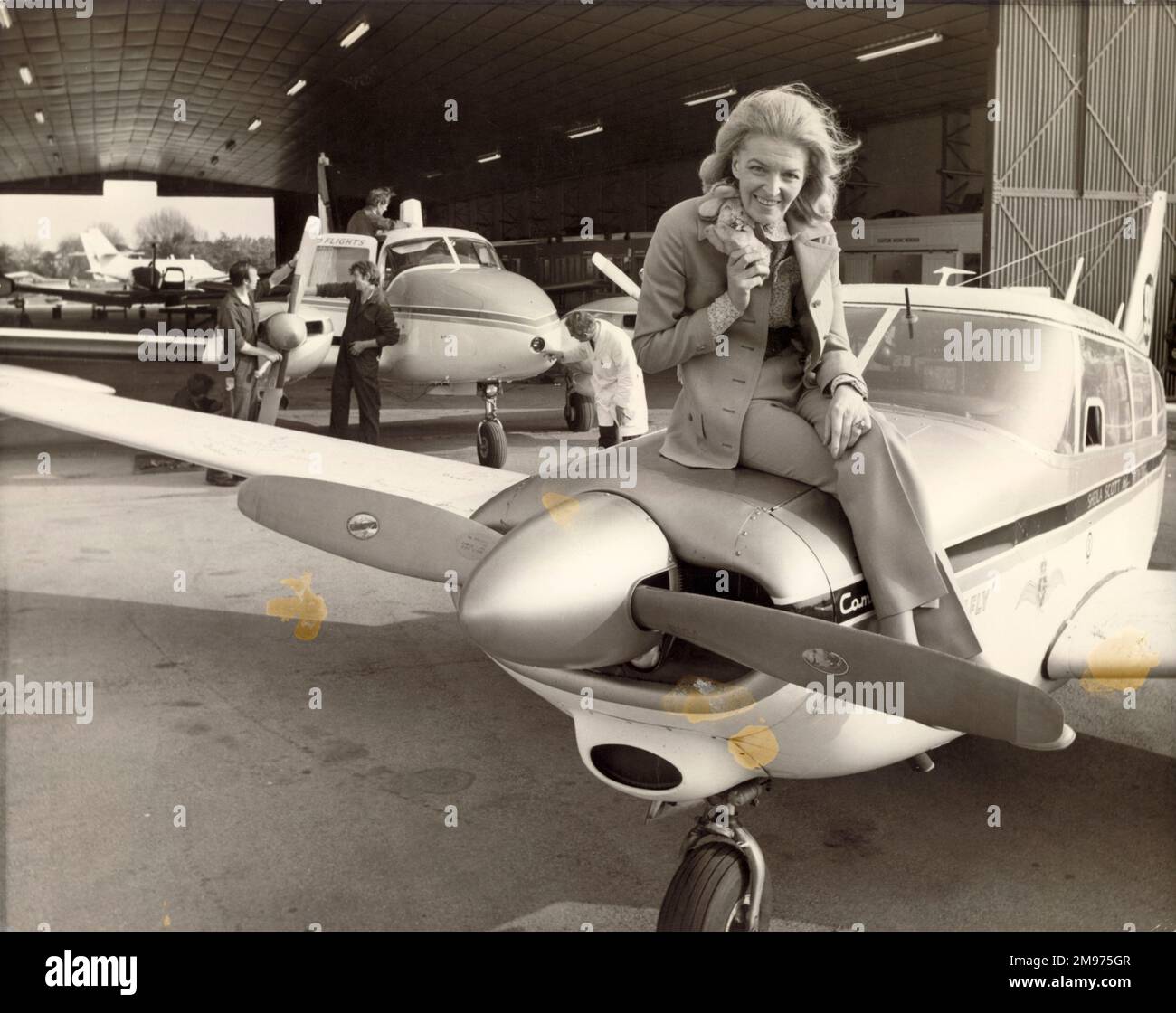 Sheila Scott, 19271988, sitting on the nose of her Piper Comanche, G