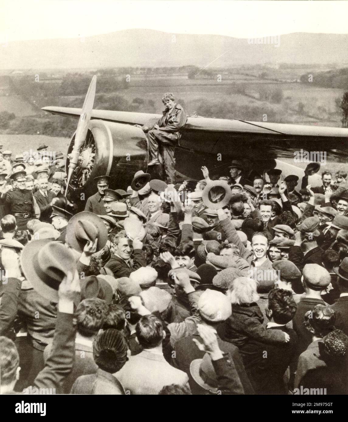 Amelia Earhart with her Lockheed Vega 5b, Old Bessie, after her arrival at Culmore, near Londonderry. 21 May 1932. Stock Photo