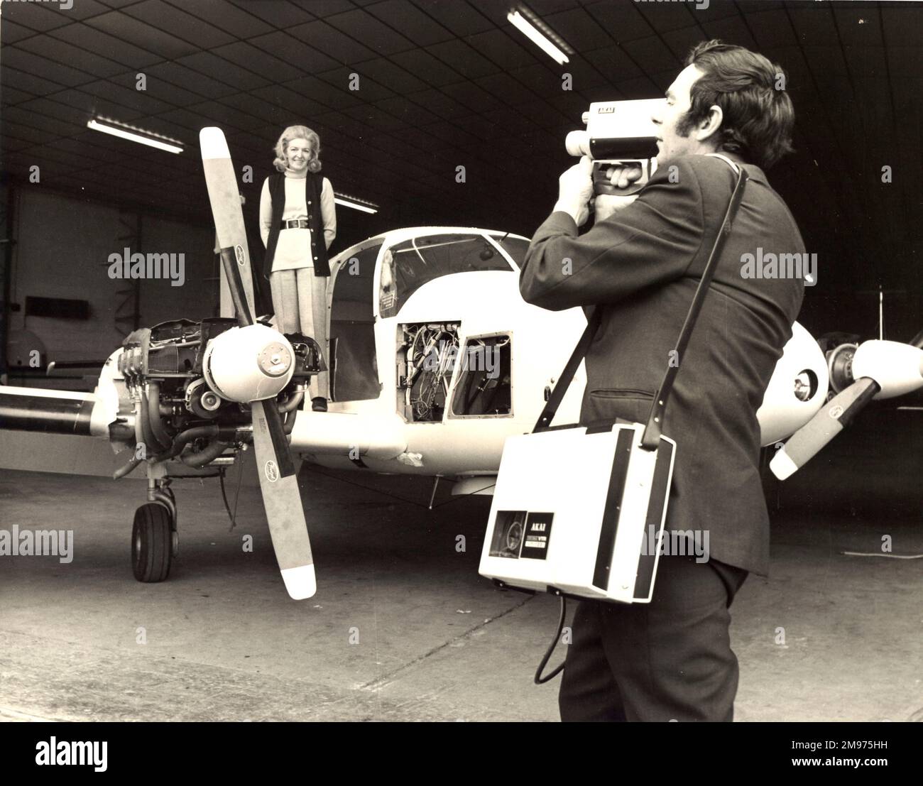 Sheila Scott on the wing of her Piper Aztec. And the lightweight Akai VT100 video recorder weighs less than 24lb! May 1971. Stock Photo