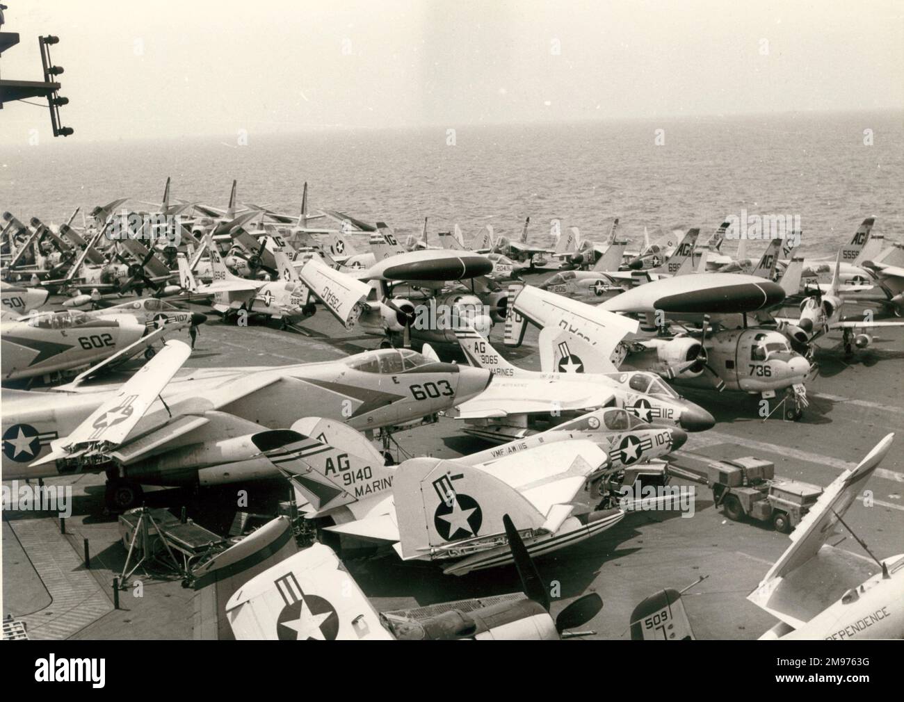 Aircraft on the deck of the USS Independence including Douglas A4D Skyhawks, Douglas A3D Skywarriers, Douglas F4D Skyrays, Grumman WF-2s, Vought F8U Crusaders and Douglas AD-1 Skyraiders. Stock Photo