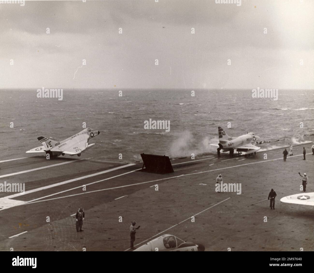 A Douglas F4D-1 Skyray and a Douglas A4D Skyhawk launch from USS Independence. Stock Photo