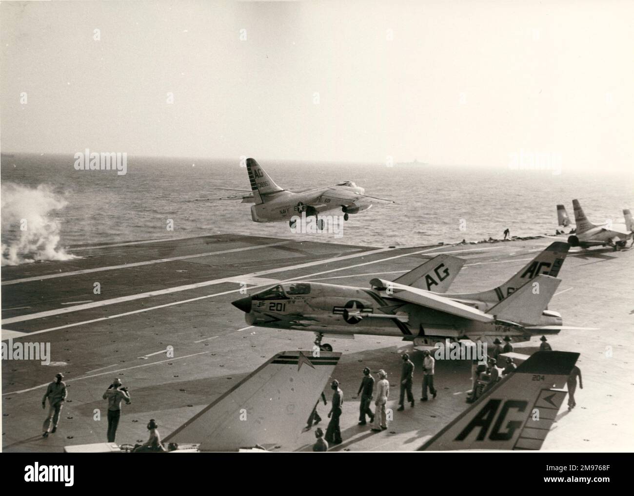 A Douglas A3D-2 Skywarrior, 138953, departs from USS Independence past a Vought F8U Crusader. Stock Photo