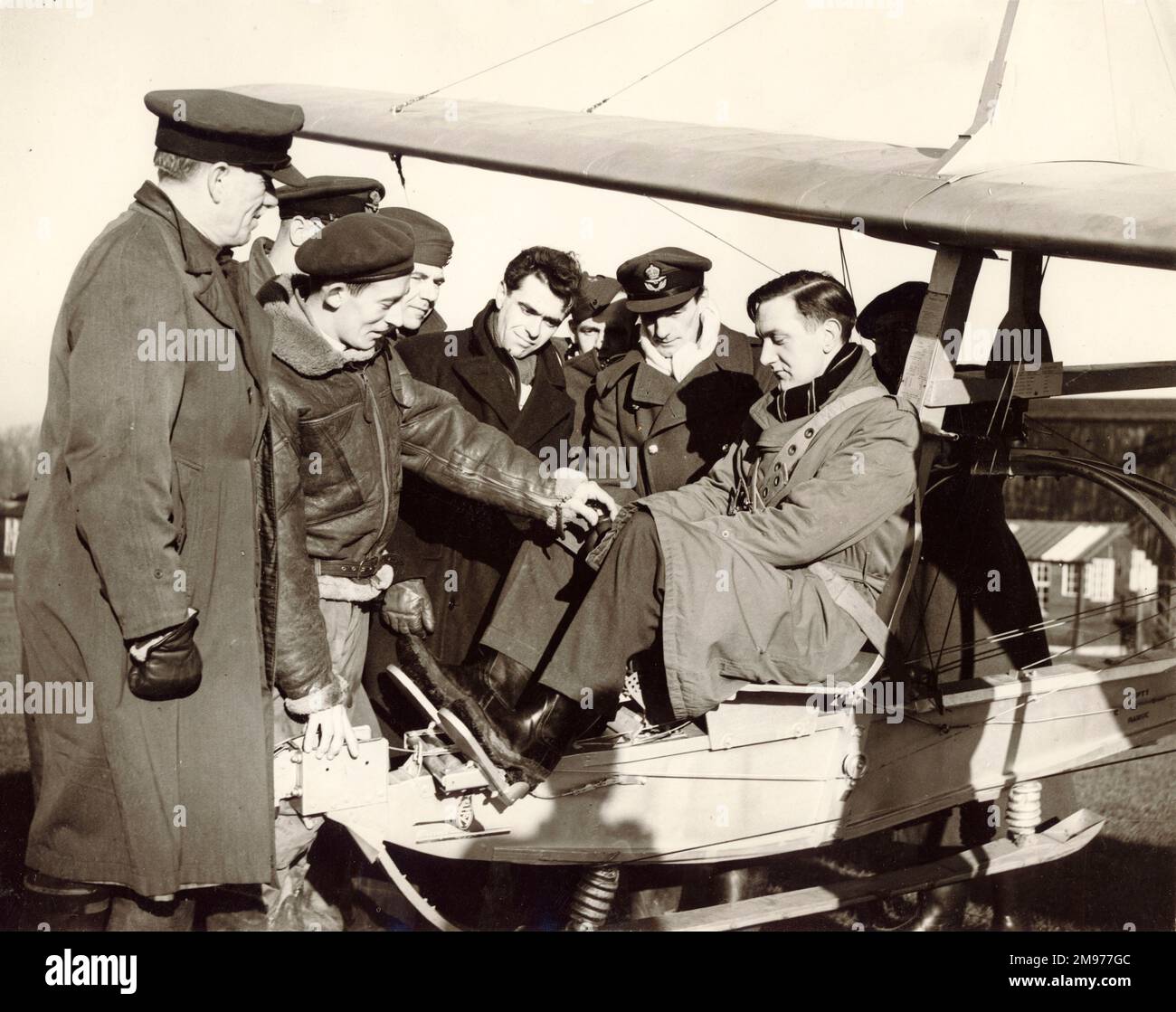 Flt Lt A.D. Piggott, the chief instructor, with a class of schoolmasters, explains the controls of a glider at Detling, near Maidstone, Kent. In the cockpit is J.L. Smith, chemistry master from Dollar Acadamy, near Stirling, Scotland. 4 January 1952. Stock Photo