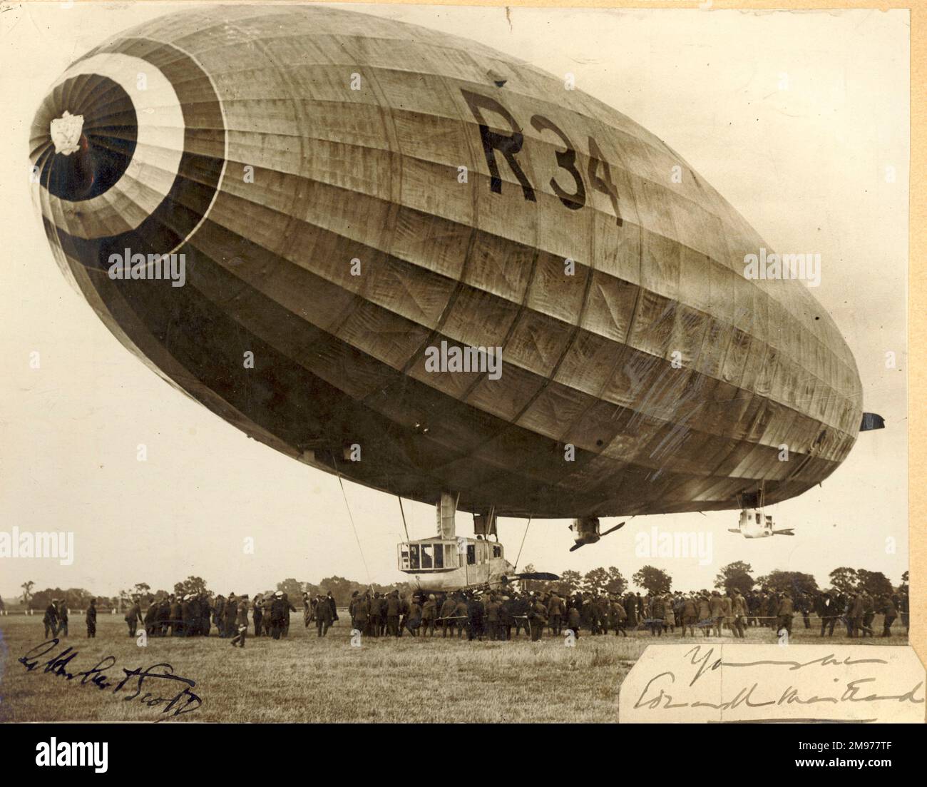 This photo of the landing R34 at Pulham on 13 July 1919, 6.57 am, on the conclusion of the voyage to and from America was given by Air Cdre E.M. Maitland. It was later signed by Major G.H. Scott, AFC. Stock Photo