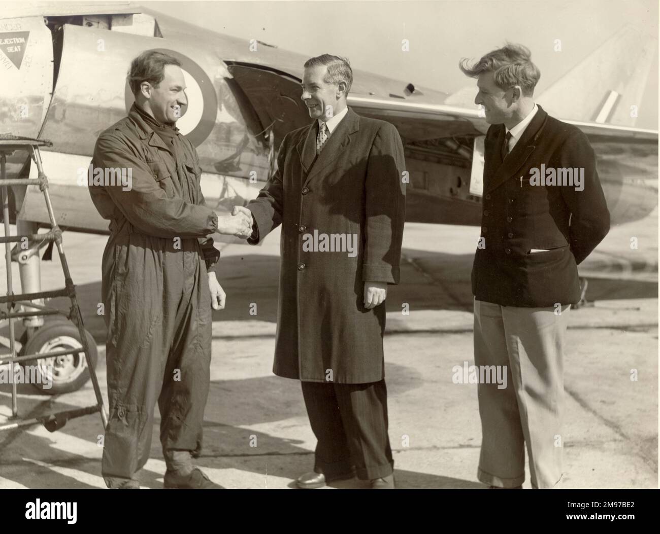 From left: Lionel Peter Twiss, OBE, DSC*, 1921-2011, is congratulated after establishing a new world air speed record in a Fairey Delta 2 by Robert Lockley, chief engineer, Fairey Aviation, who was responsible for the design of the aircraft and Maurice Childs, chief flight development engineer. Stock Photo