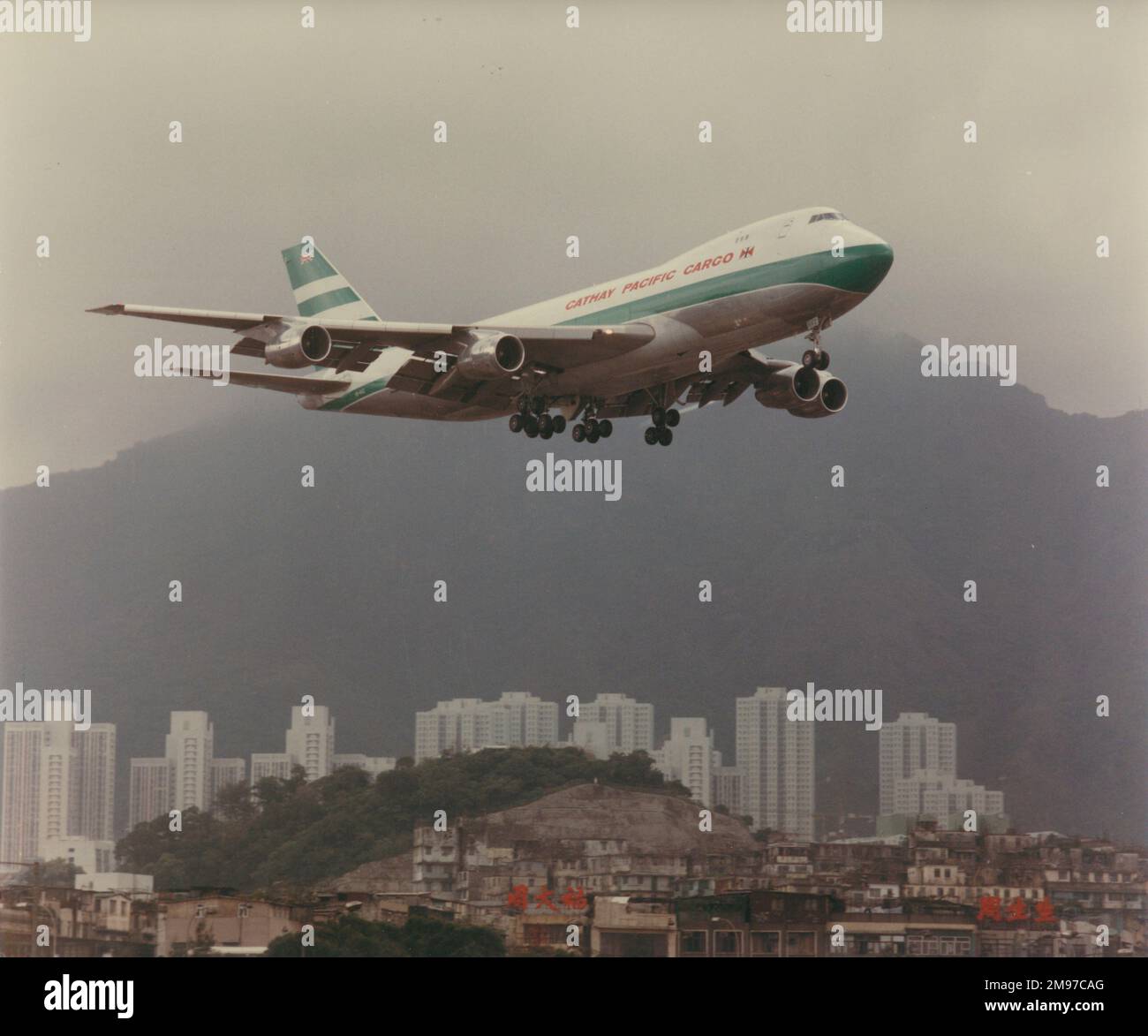 Boeing 747 of Cathay Pacific over Kai Tak airport, Hong Kong. Stock Photo
