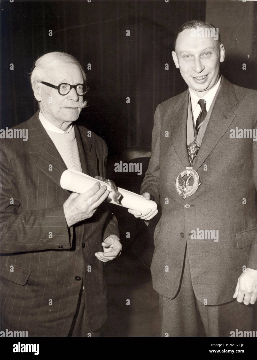 Gustavus Green, left, being presented with his Honorary Companionship certificate by Sir Arnold Hall, RAeS President 1958-1959. Stock Photo