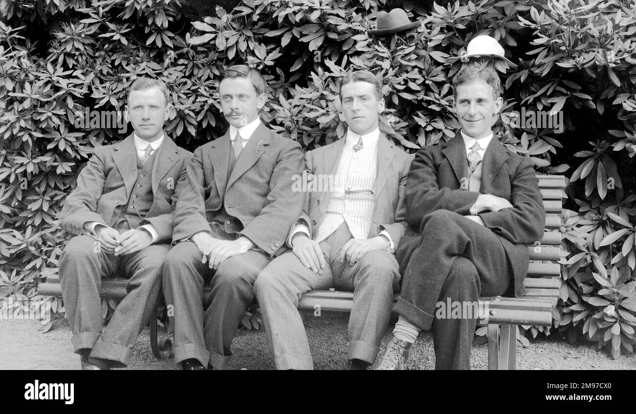 Group of four men with hats, showing a delightful glimpse of humour. Exactly what was going on here is unknnown, the photographer Ernest Battersby (second from left) did not leave any notes to explain! Stock Photo